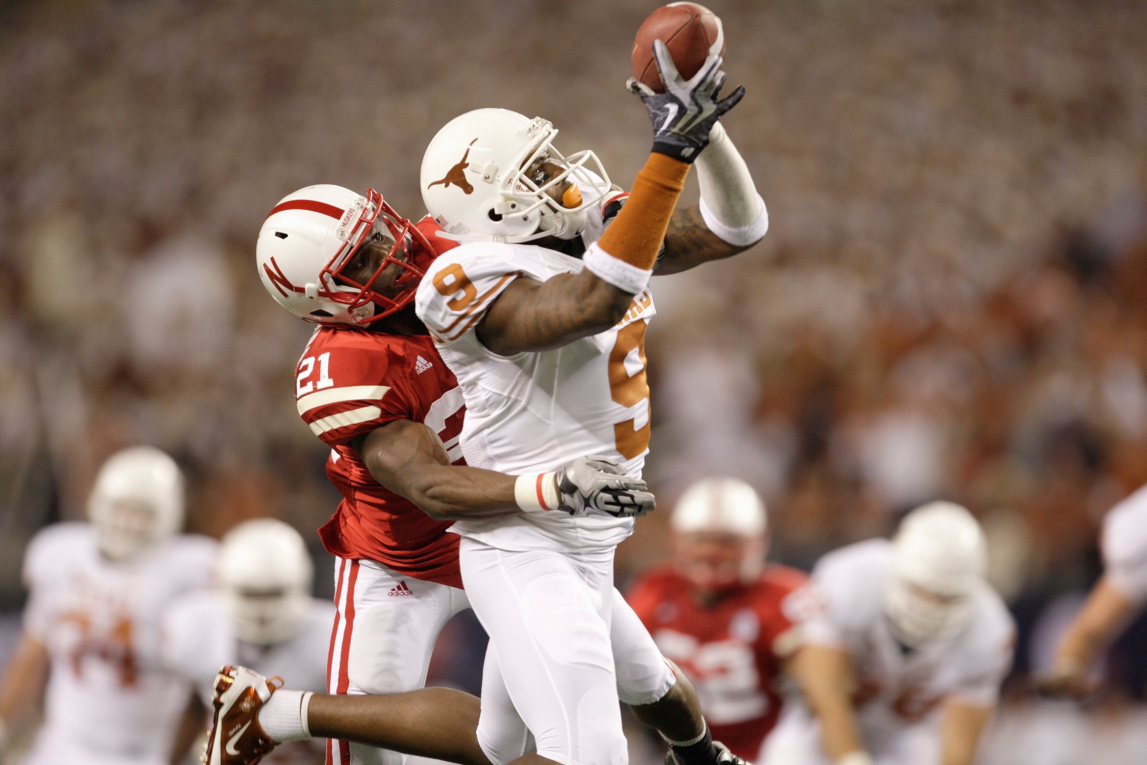 ARLINGTON, TX - DECEMBER 5: Malcolm Williams #9 of the Texas Longhorns makes a catch in front of Prince Amukamara #21 of the Nebraska Cornhuskers in the second quarter of the game at Cowboys Stadium on December 5, 2009 in Arlington, Texas. (Photo by Jamie