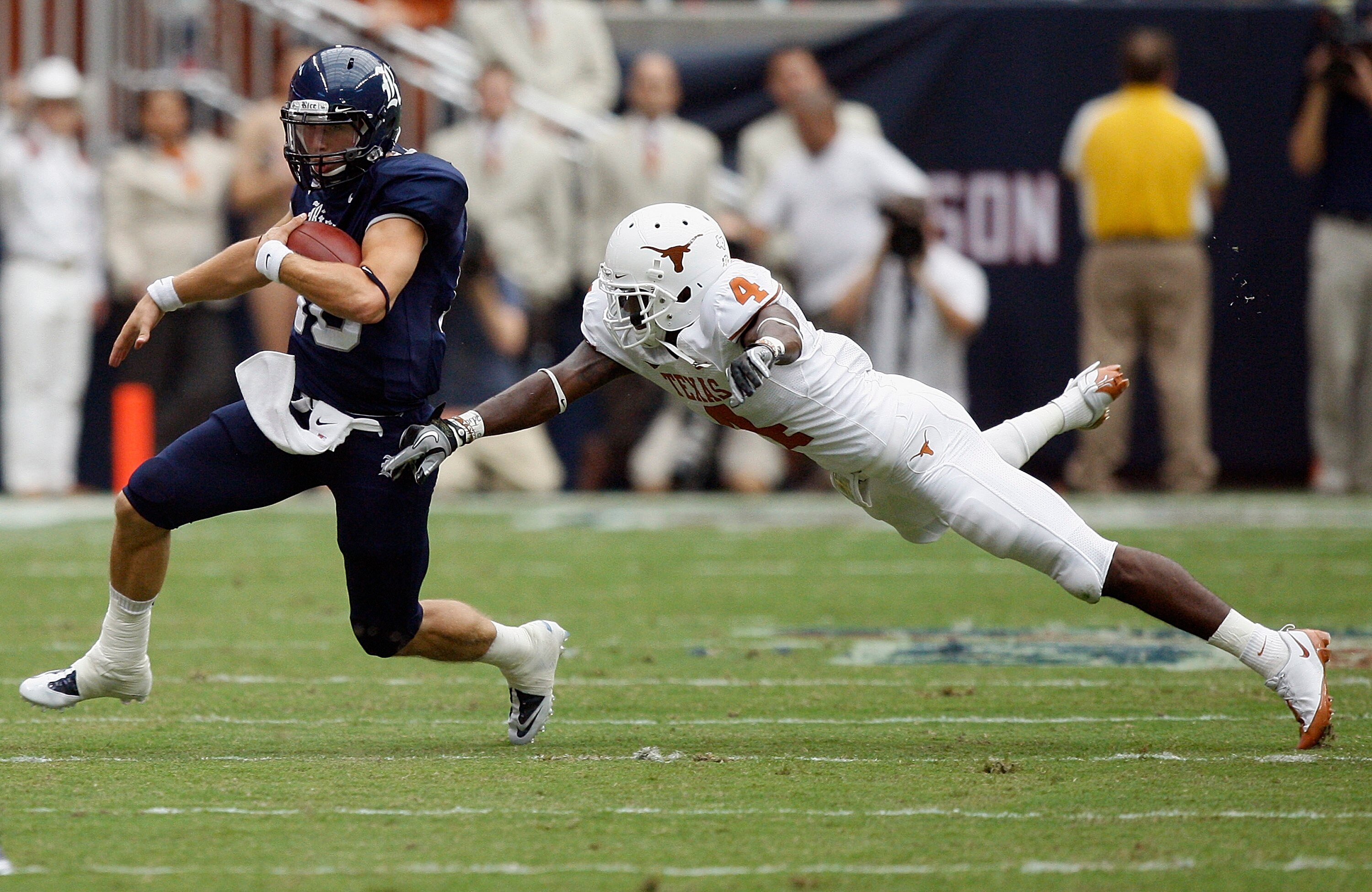 HOUSTON - SEPTEMBER 04:  Quarterback Taylor McHargue #16 of the Rice Owls avoids a diving cornerback Aaron Williams #4 of the Texas Longhorns at Reliant Stadium on September 4, 2010 in Houston, Texas.  (Photo by Bob Levey/Getty Images)