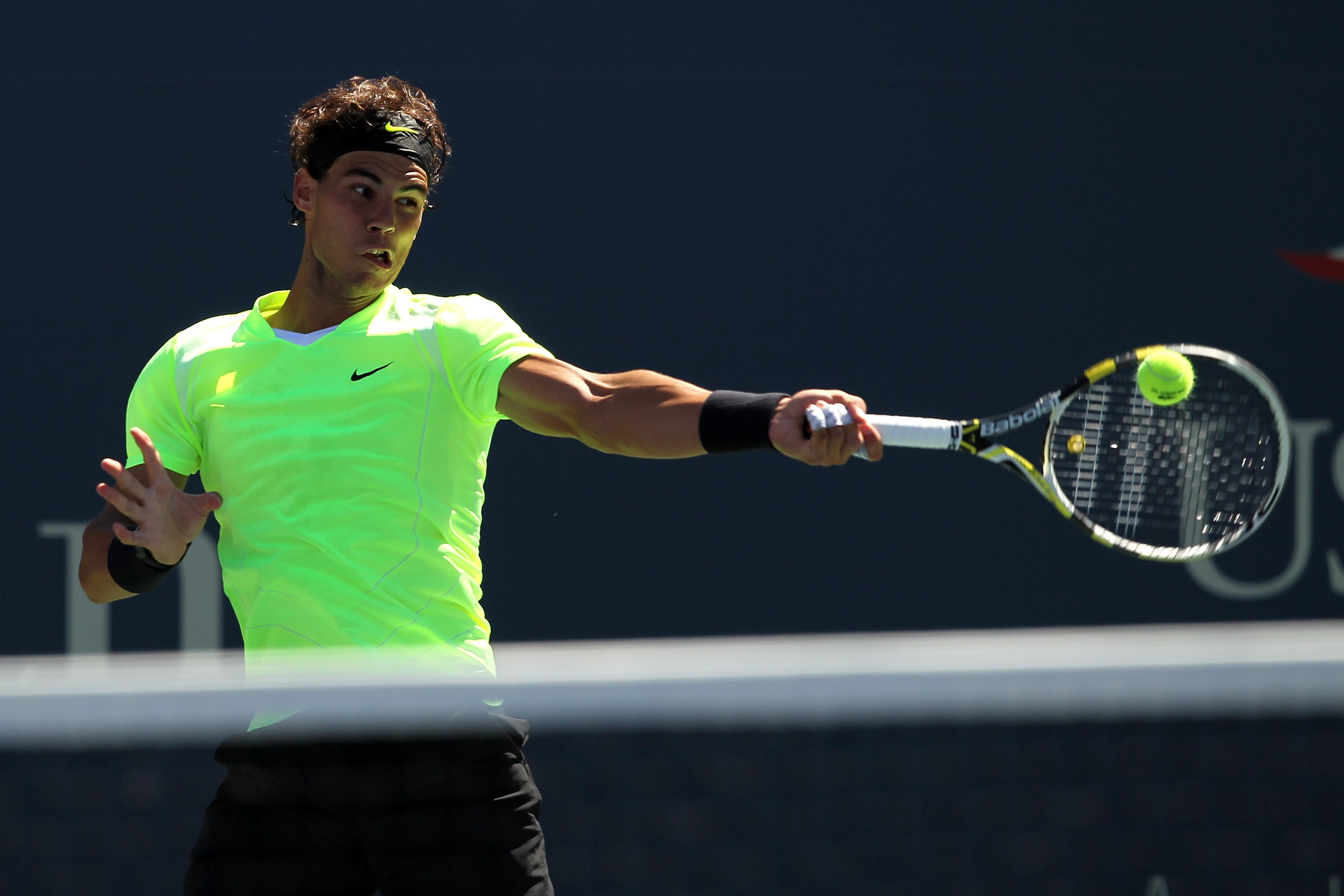 NEW YORK - SEPTEMBER 11:  Rafael Nadal of Spain returns a shot while playing against Mikhail Youzhny of Russia during his men's singles semifinal match on day thirteen of the 2010 U.S. Open at the USTA Billie Jean King National Tennis Center on September