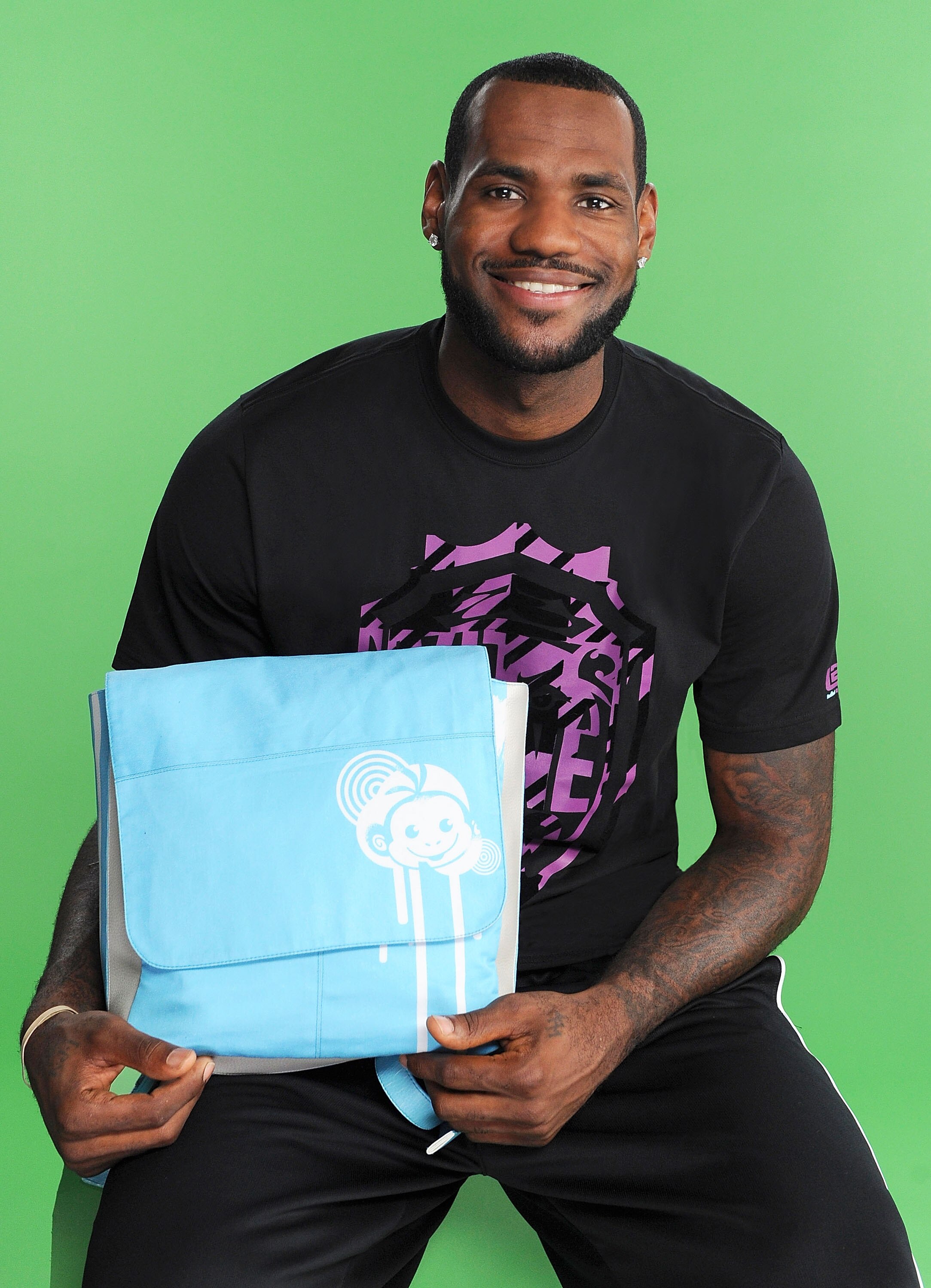 NEW YORK - AUGUST 10:  Lebron James holds his custom-made Dora The Explorer backpack. Nickelodeon unveiled 12 custom-made backpacks today in the world-famous windows of Macyï¿½s Herald Square in New York City. The backpacks were personally designed and sign