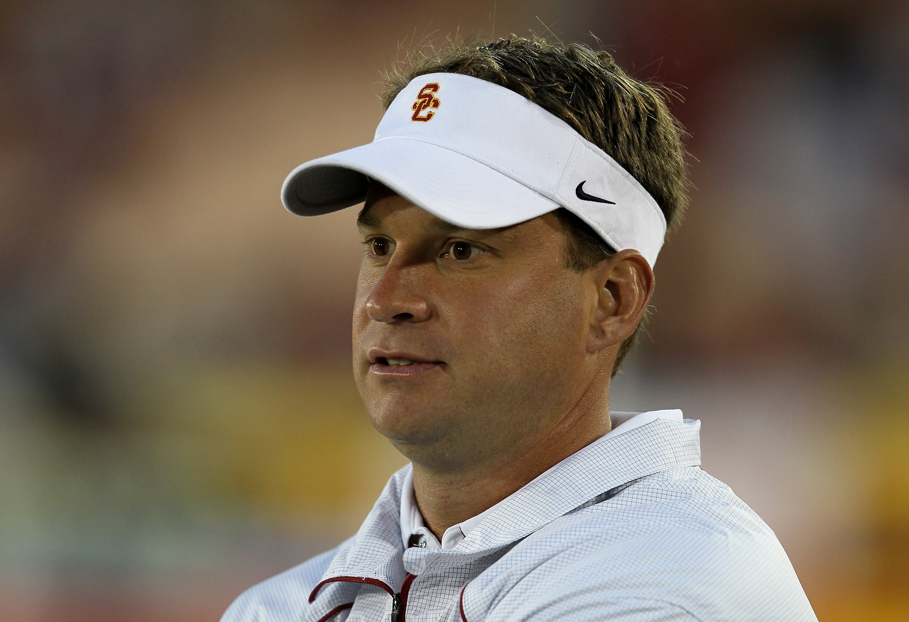LOS ANGELES, CA - SEPTEMBER 11:  Head coach Lane Kiffin watches the USC Trojans warm up for their game with the Virginia Cavaliers at Los Angeles Memorial Coliseum on September 11, 2010 in Los Angeles, California.  (Photo by Stephen Dunn/Getty Images)