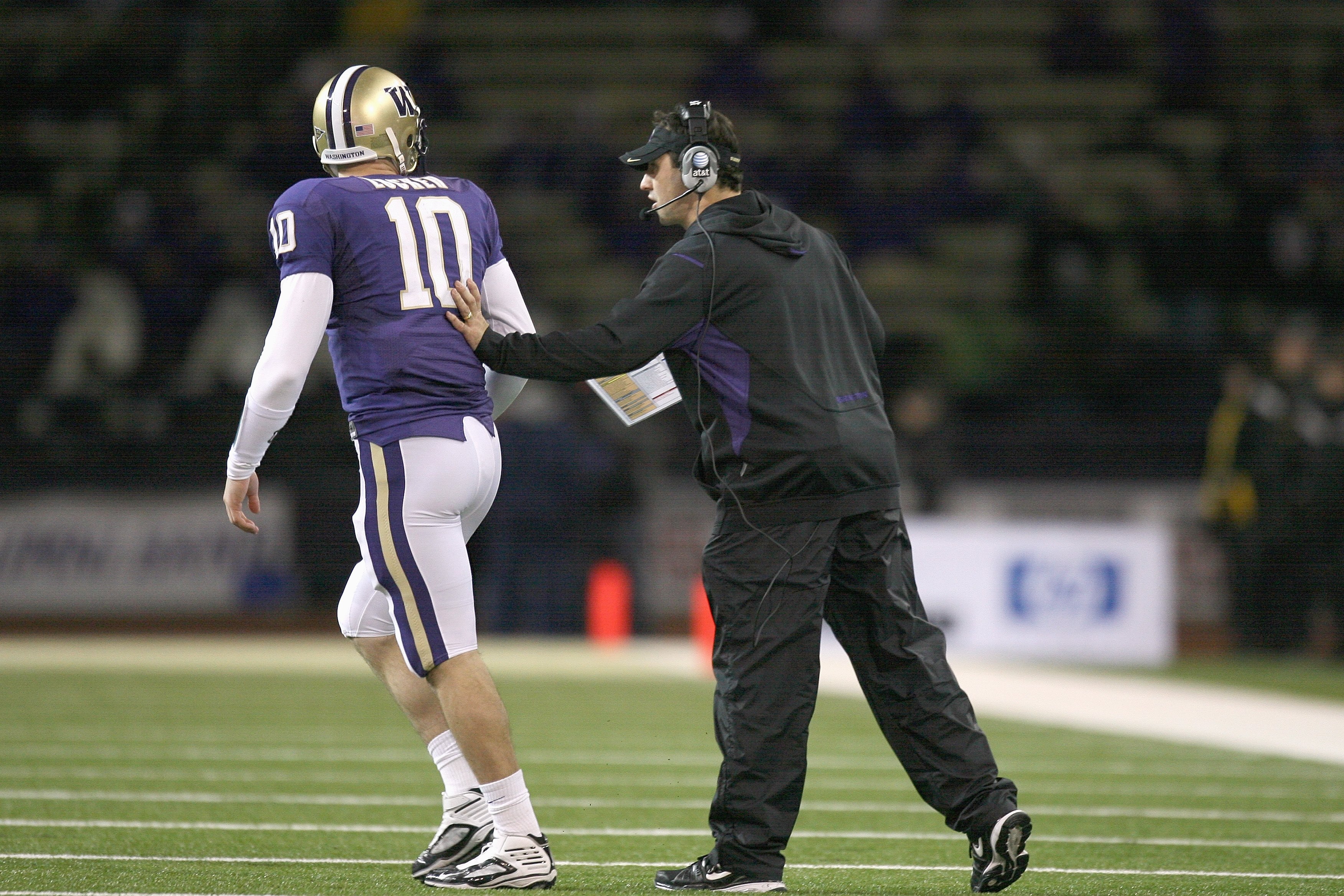 SEATTLE - DECEMBER 05:  Quarterback Jake Locker #10 of the Washington Huskies gets a push from head coach Steve Sarkisian during the game against the California Bears on December 5, 2009 at Husky Stadium in Seattle, Washington. The Huskies defeated the Be
