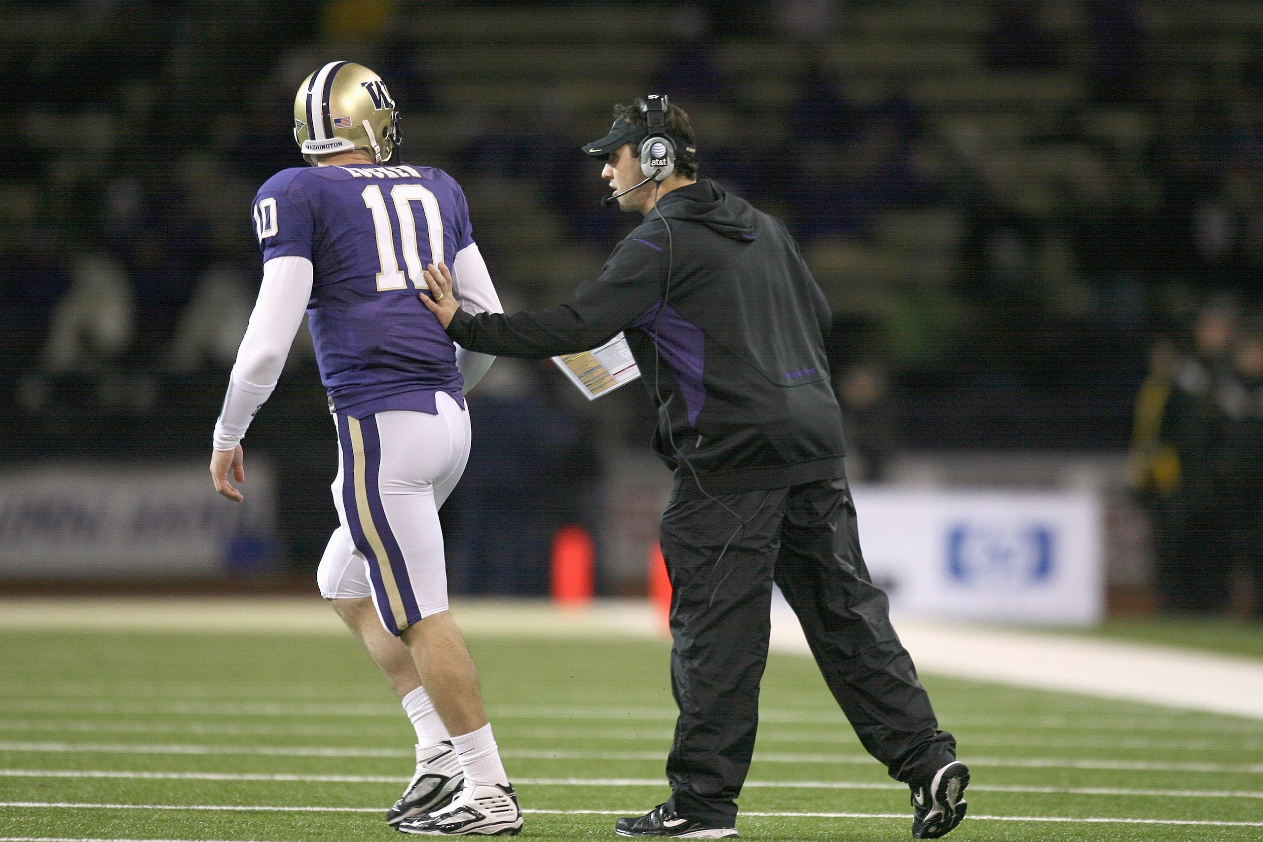 SEATTLE - DECEMBER 05:  Quarterback Jake Locker #10 of the Washington Huskies gets a push from head coach Steve Sarkisian during the game against the California Bears on December 5, 2009 at Husky Stadium in Seattle, Washington. The Huskies defeated the Be