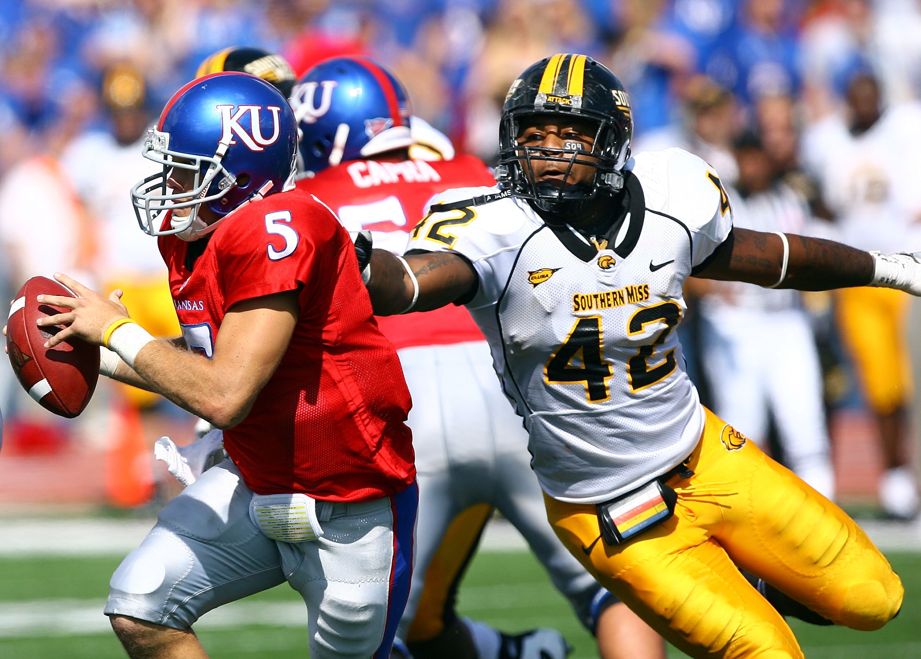 LAWRENCE, KS - SEPTEMBER 26:  Quarterback Todd Reesing #5 of the Kansas Jayhawks evades Korey Williams # 42 of the Southern Mississippi Golden Eagles during the game on September 26, 2009 at Memorial Stadium in Lawrence, Kansas.  (Photo by Jamie Squire/Ge