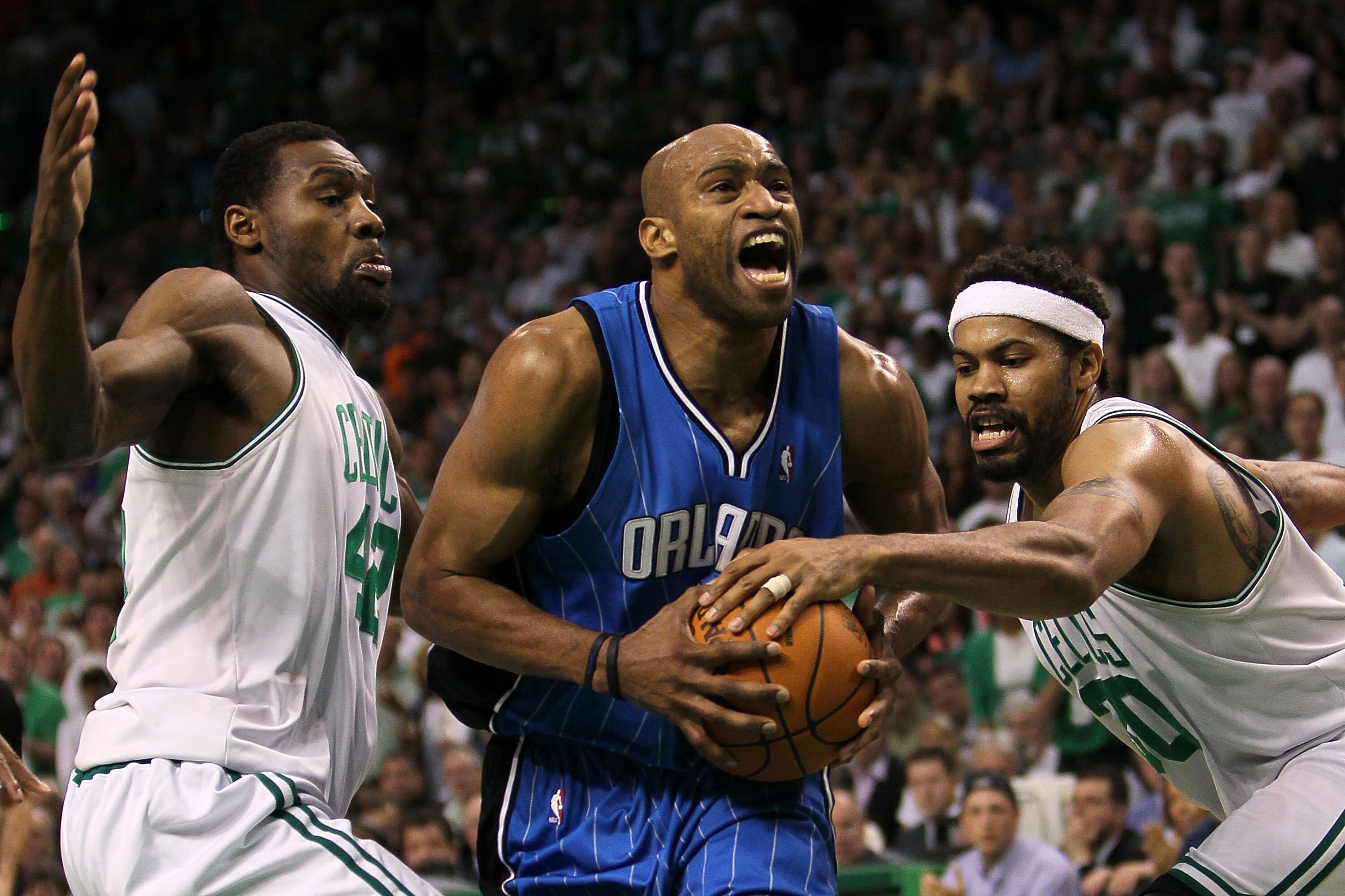 BOSTON - MAY 28:  Vince Carter #15 of the Orlando Magic drives against Tony Allen #42 (L) and Rasheed Wallace #30 of the Boston Celtics in Game Six of the Eastern Conference Finals during the 2010 NBA Playoffs at TD Garden on May 28, 2010 in Boston, Massa