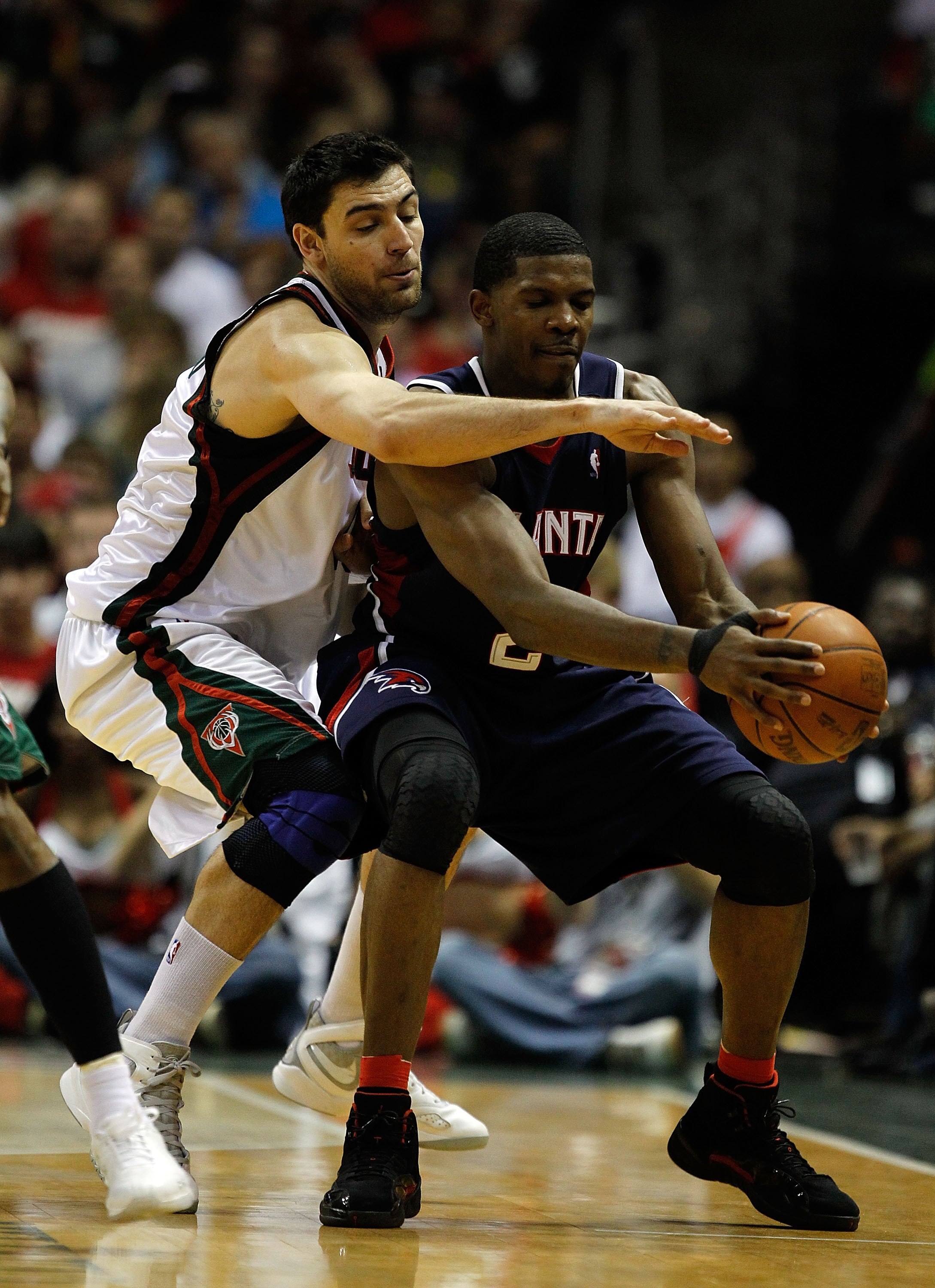 MILWAUKEE - APRIL 30: Joe Johnson #2 of the Atlanta Hawks is pressured by Carlos Delfino #10 of the Milwaukee Bucks in Game Six of the Eastern Conference Quarterfinals during the 2010 NBA Playoffs at the Bradley Center on April 30, 2010 in Milwaukee, Wisc