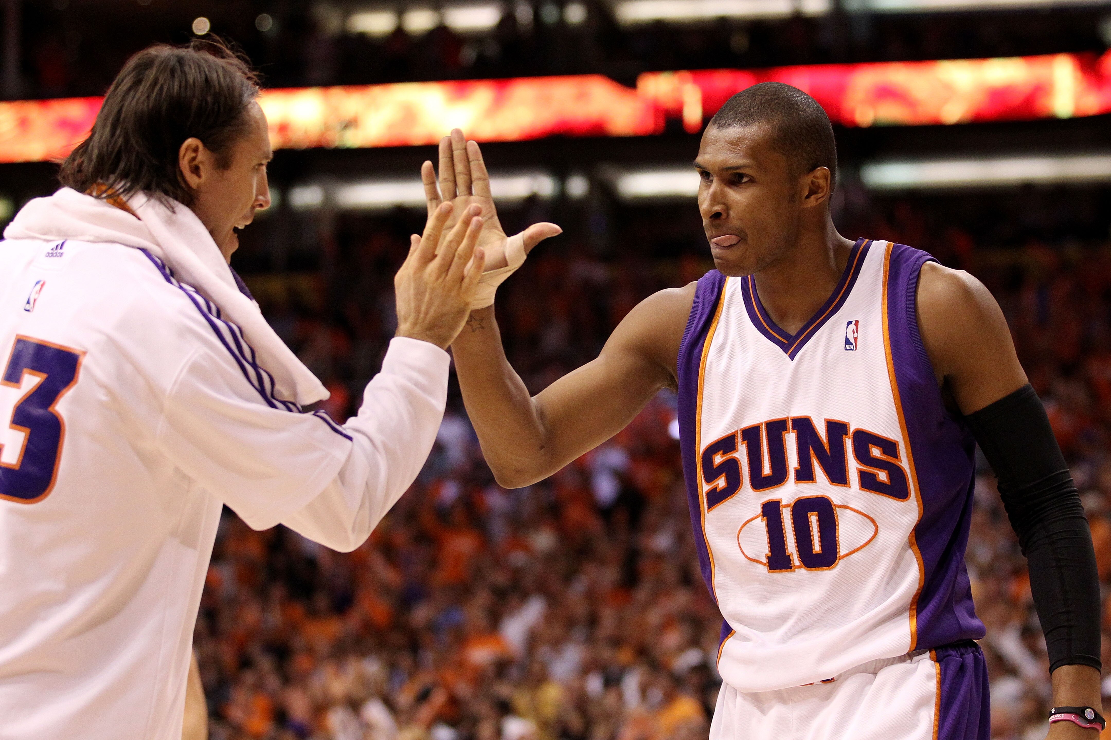 PHOENIX - MAY 25:  Steve Nash #13 of the Phoenix Suns congratulates teammate Leandro Barbosa #10 after a play against the Los Angeles Lakers in the fourth quarter of Game Four of the Western Conference Finals during the 2010 NBA Playoffs at US Airways Cen