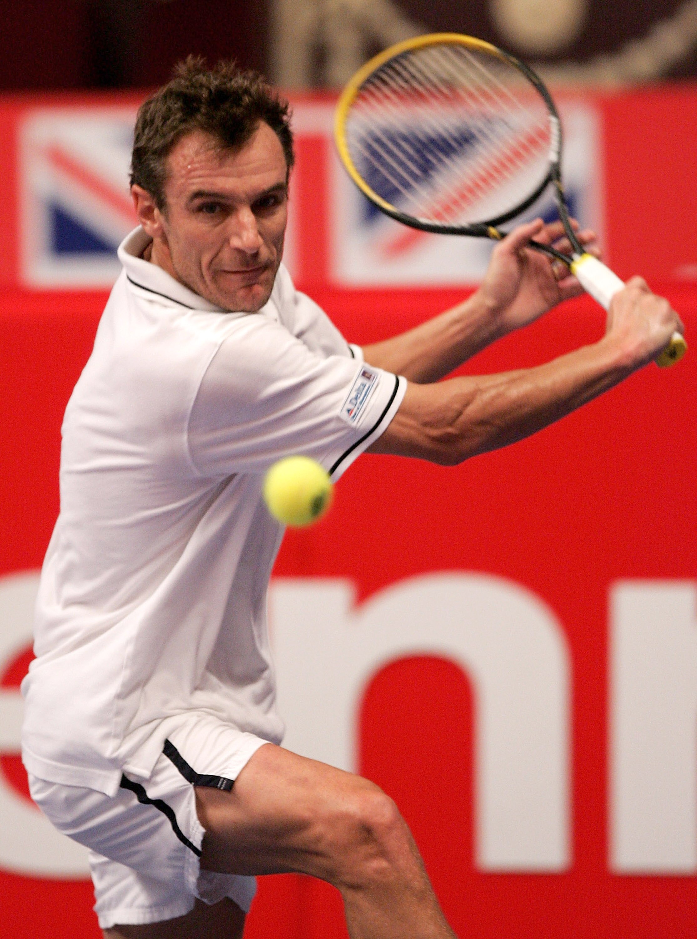 LONDON - DECEMBER 1:  Mats Wilander of Sweden returns the ball to Guy Forget of France during the Masters Tennis tournament on December 1, 2004 at the Royal Albert Hall in London, England.  (Photo by Julian Finney/Getty Images)