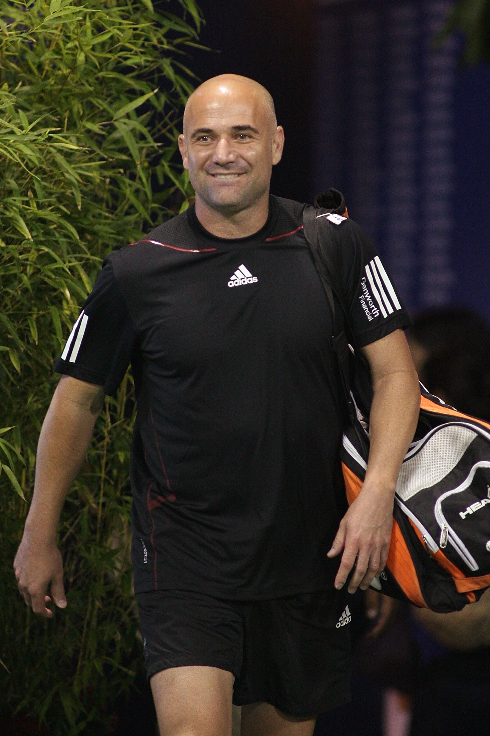 LOS ANGELES, CA - JULY 24:  Andre Agassi smiles as he enters the stadium to play against John McEnroe during the Stars Under the Stars gala on July 24, 2010 at the Los Angeles Tennis Center in Los Angeles, California.  Andre Agassi defeated John McEnroe 6
