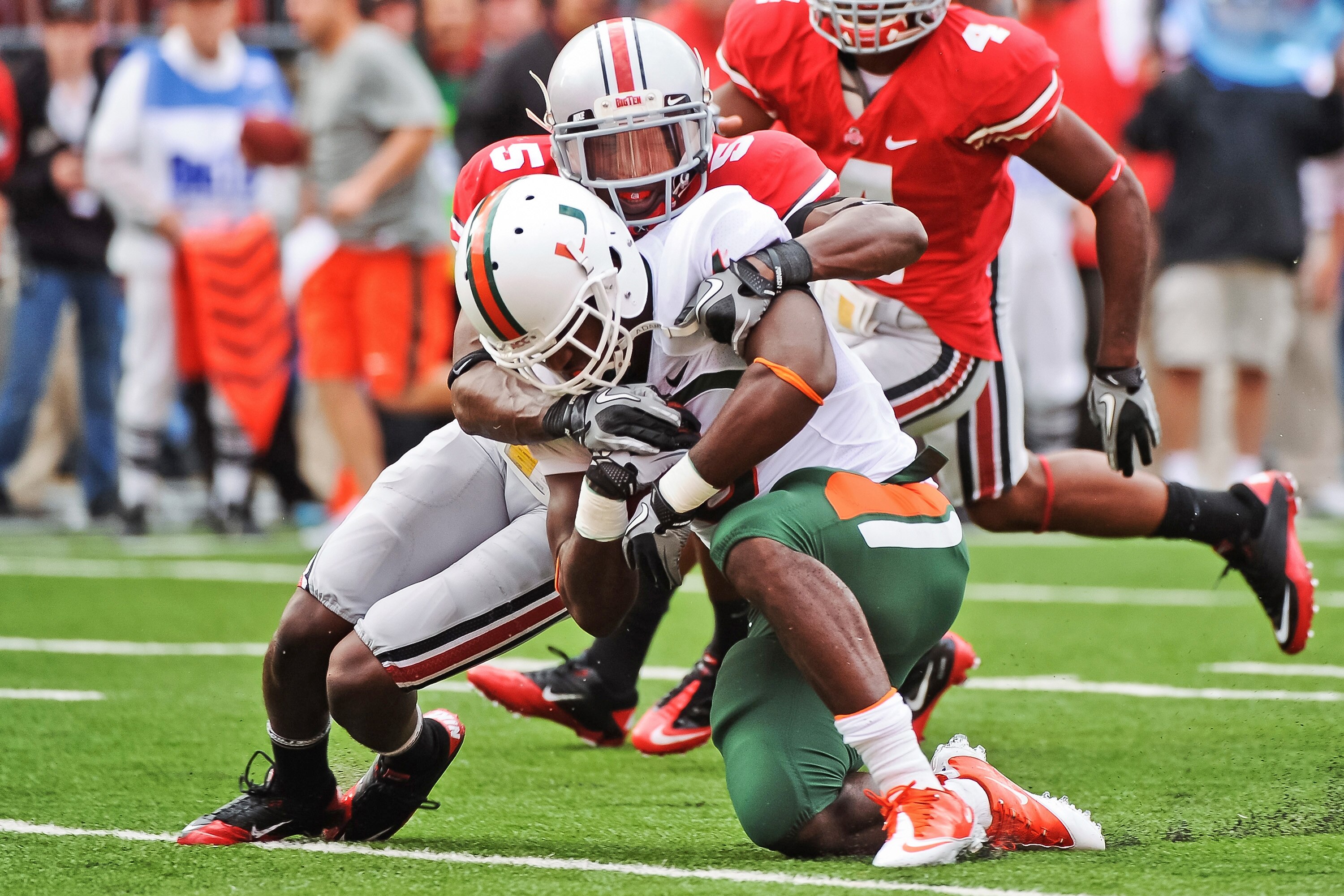 COLUMBUS, OH - SEPTEMBER 11:  Chimdi Chekwa #5 of the Ohio State Buckeyes tackles Lamar Miller #6 of the Miami Hurricanes at Ohio Stadium on September 11, 2010 in Columbus, Ohio.  (Photo by Jamie Sabau/Getty Images)