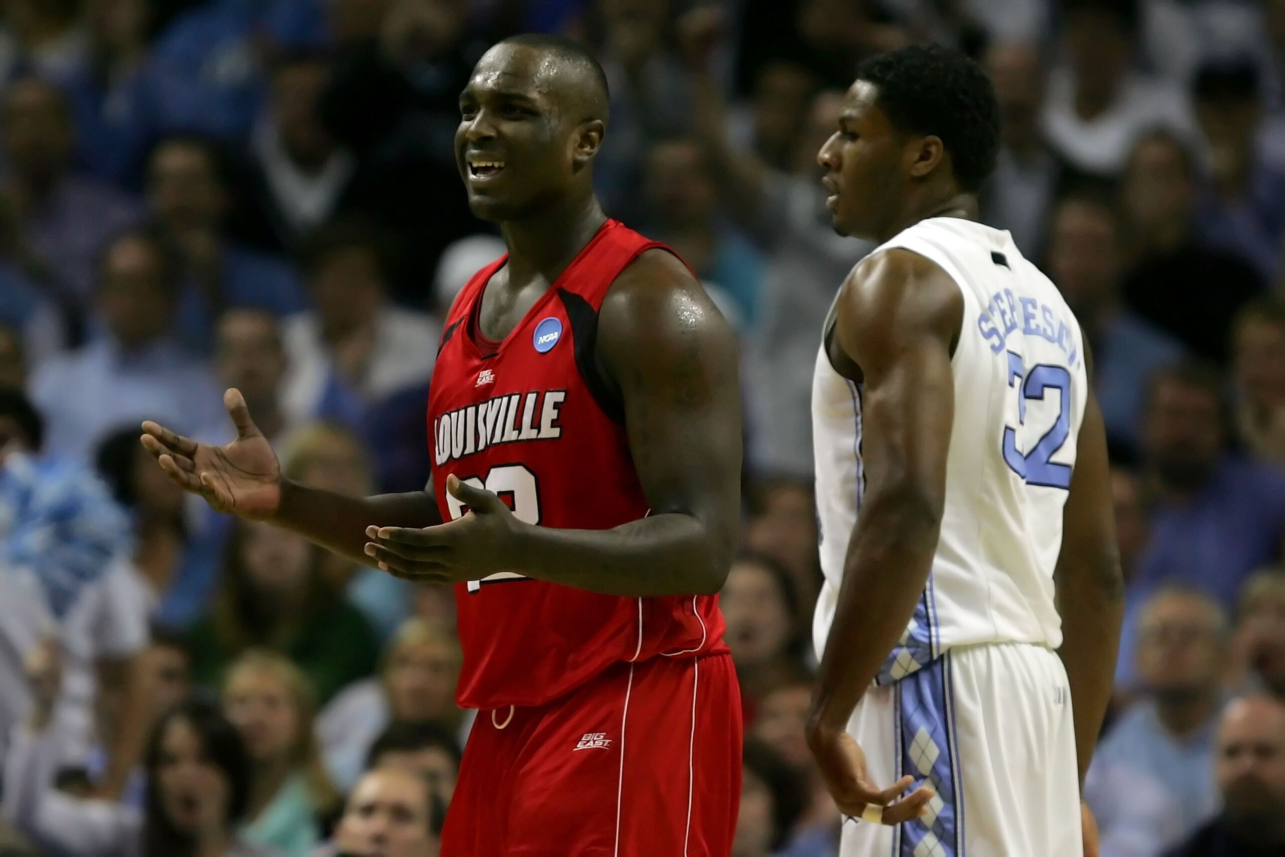 CHARLOTTE, NC - MARCH 29:  Derrick Caracter #32 of the Louisville Cardinals reacts as he stands alongside Alex Stepheson #32 of the North Carolina Tar Heels during the 2008 NCAA Men's East Regional Final at Bobcats Arena on March 29, 2008 in Charlotte, No