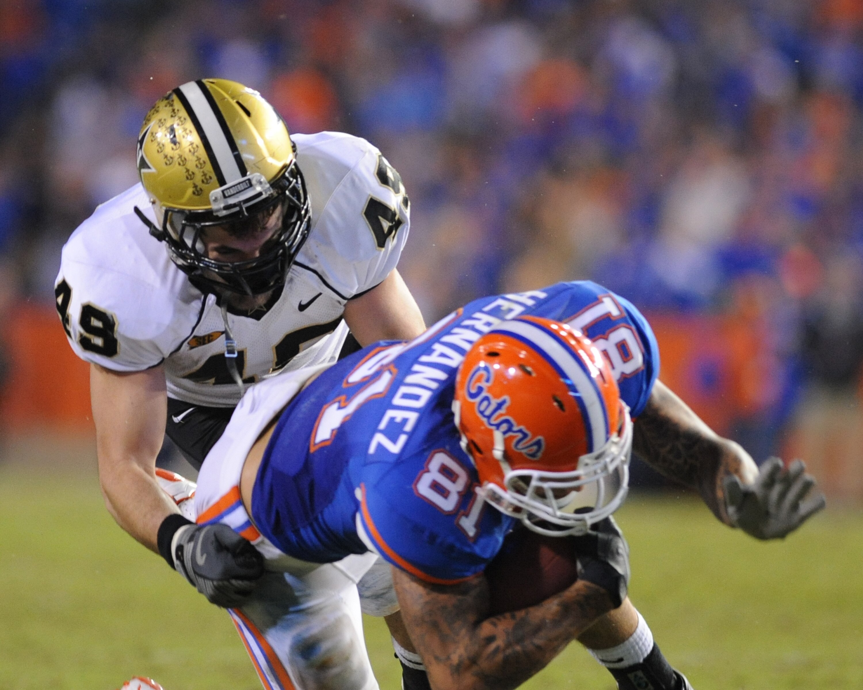 GAINESVILLE, FL - NOVEMBER 7: Linebacker John Stokes #49 of the Vanderbilt Commodores tackles tight end Aaron Hernandez #81 of the Florida Gators November 7, 2009 at Ben Hill Griffin Stadium in Gainesville, Florida. (Photo by Al Messerschmidt/Getty Imag GAINESVILLE, FL - NOVEMBER 7: Linebacker John Stokes #49 of the Vanderbilt Commodores tackles tight end Aaron Hernandez #81 of the Florida Gators November 7, 2009 at Ben Hill Griffin Stadium in Gainesville, Florida. (Photo by Al Messerschmidt/Getty Imag