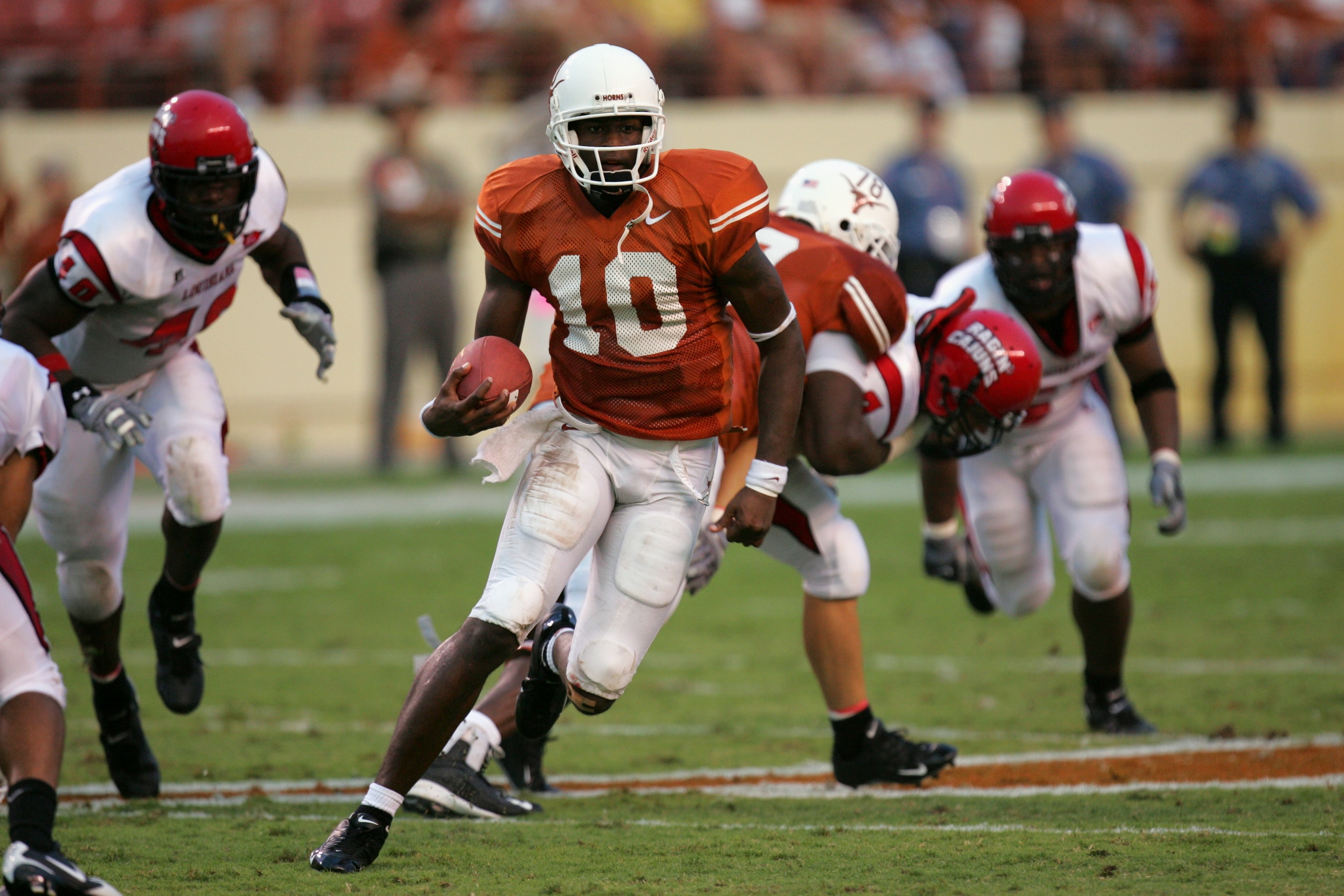 AUSTIN, TX - SEPTEMBER 3: Vince Young #10 of the Texas Longhorns carries the ball against the Louisiana-Lafayette Rajin' Cajuns on September 3, 2005 at Darrell K Royal-Texas Memorial Stadium in Austin, Texas. The Longhorns defeated the Rajin' Cajuns 60- AUSTIN, TX - SEPTEMBER 3: Vince Young #10 of the Texas Longhorns carries the ball against the Louisiana-Lafayette Rajin' Cajuns on September 3, 2005 at Darrell K Royal-Texas Memorial Stadium in Austin, Texas. The Longhorns defeated the Rajin' Cajuns 60-