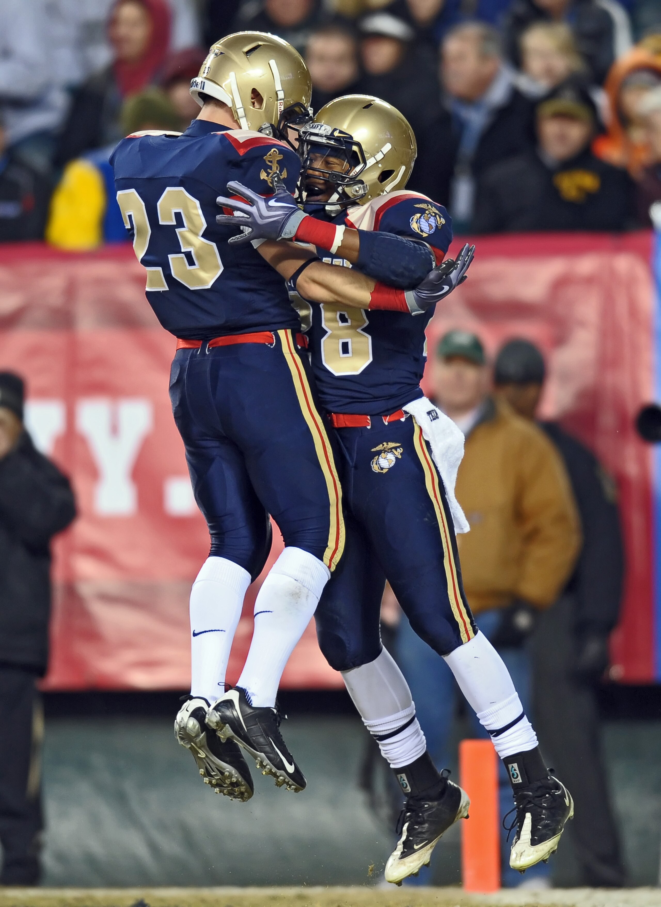 PHILADELPHIA - DECEMBER 12: Running back Marcus Curry #28 and running back Cory Finnerty # 23 of the Navy Midshipmen celebrate Curry's touchdown reception during the game against the Army Black Knights on December 12, 2009 at Lincoln Financial Field in Ph