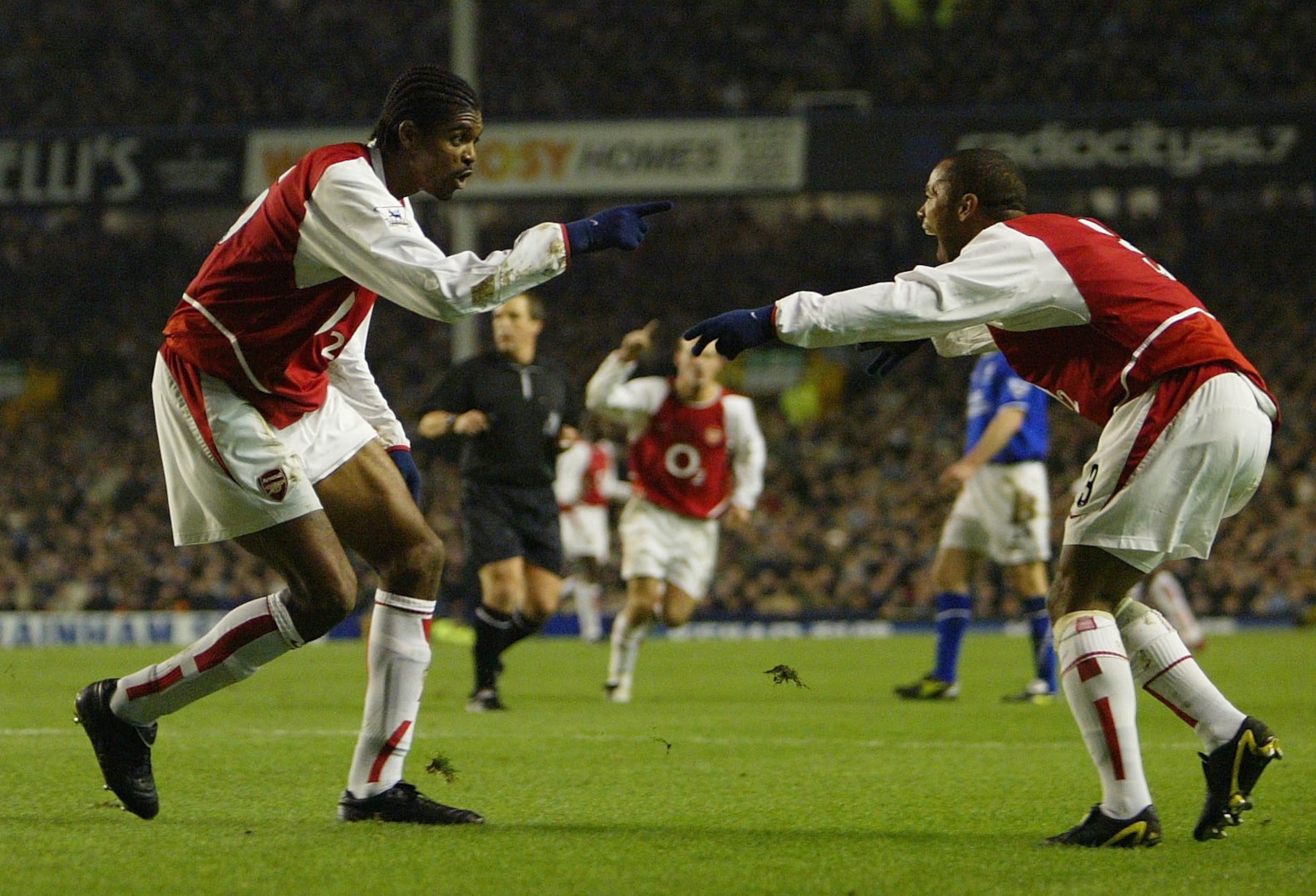 LIVERPOOL, ENGLAND - JANUARY 7:  Kanu of Arsenal celebrates with team mate Ashley Cole after scoring the opening goal during the FA Barclaycard Premiership match between Everton and Arsenal at Goodison Park on January 7, 2004 in Liverpool, England.  (Phot