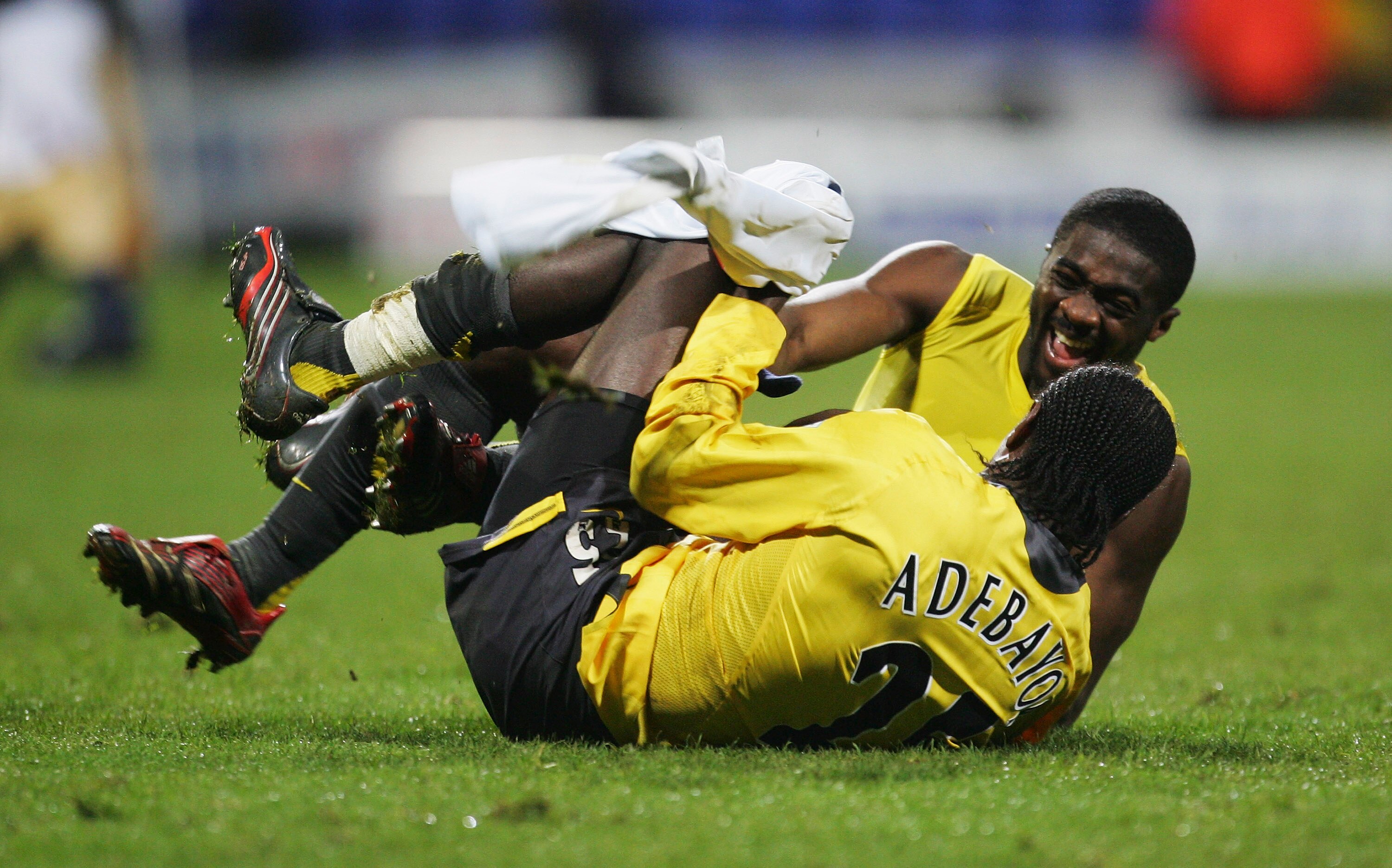 BOLTON, UNITED KINGDOM - FEBRUARY 14:  Emmanuel Adebayor of Arsenal celebrates with team mate Kolo Toure folllowing their team's victory at the end of the FA Cup sponsored by E.ON 4th Round Replay match between Bolton Wanderers and Arsenal at the Reebok S