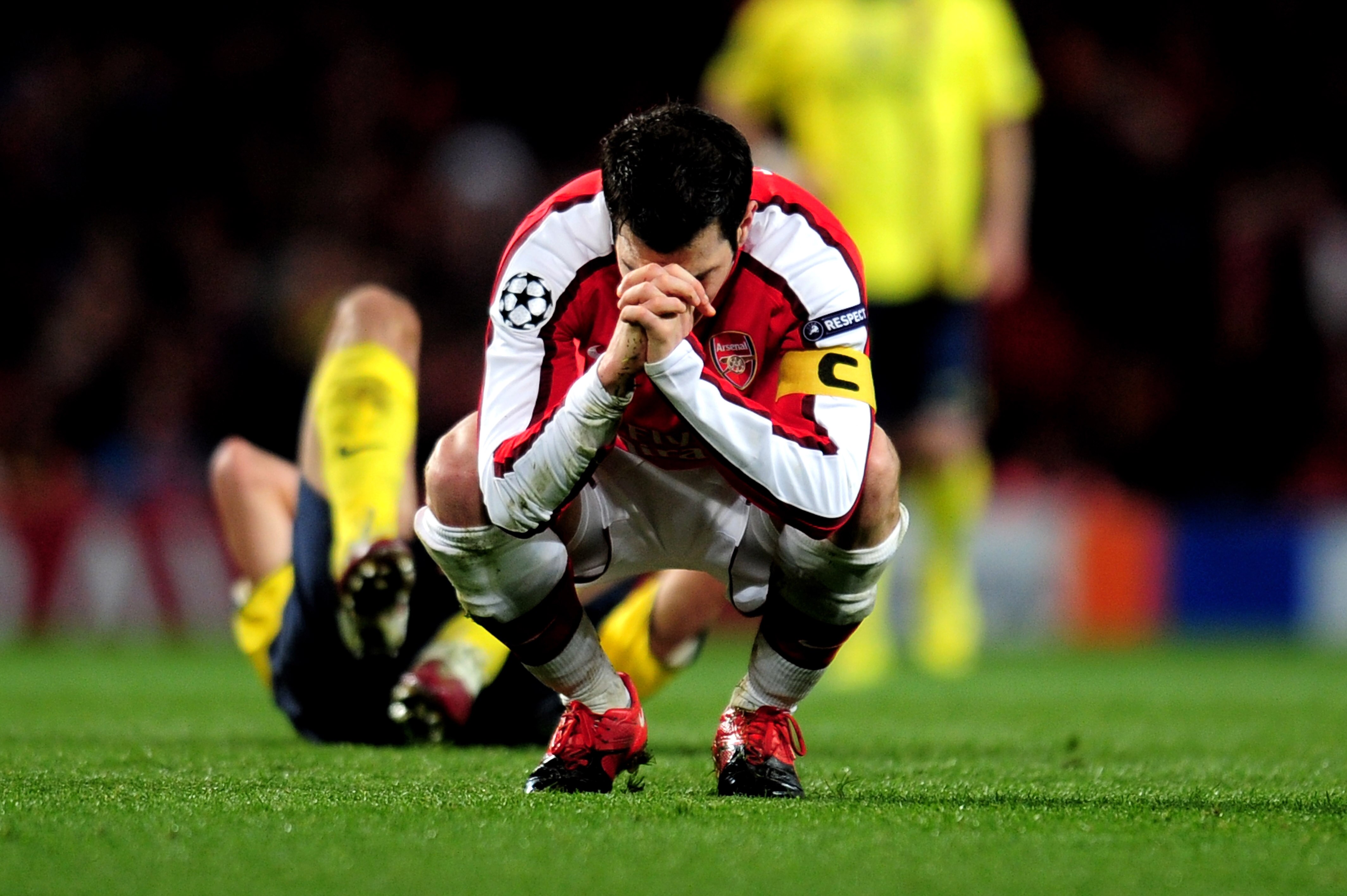 LONDON, ENGLAND - MARCH 31:  Cesc Fabregas of Arsenal reacts after being shown a yellow card by referee Massimo Busacca of Switerland during the UEFA Champions League quarter final first leg match between Arsenal and FC Barcelona at the Emirates Stadium o