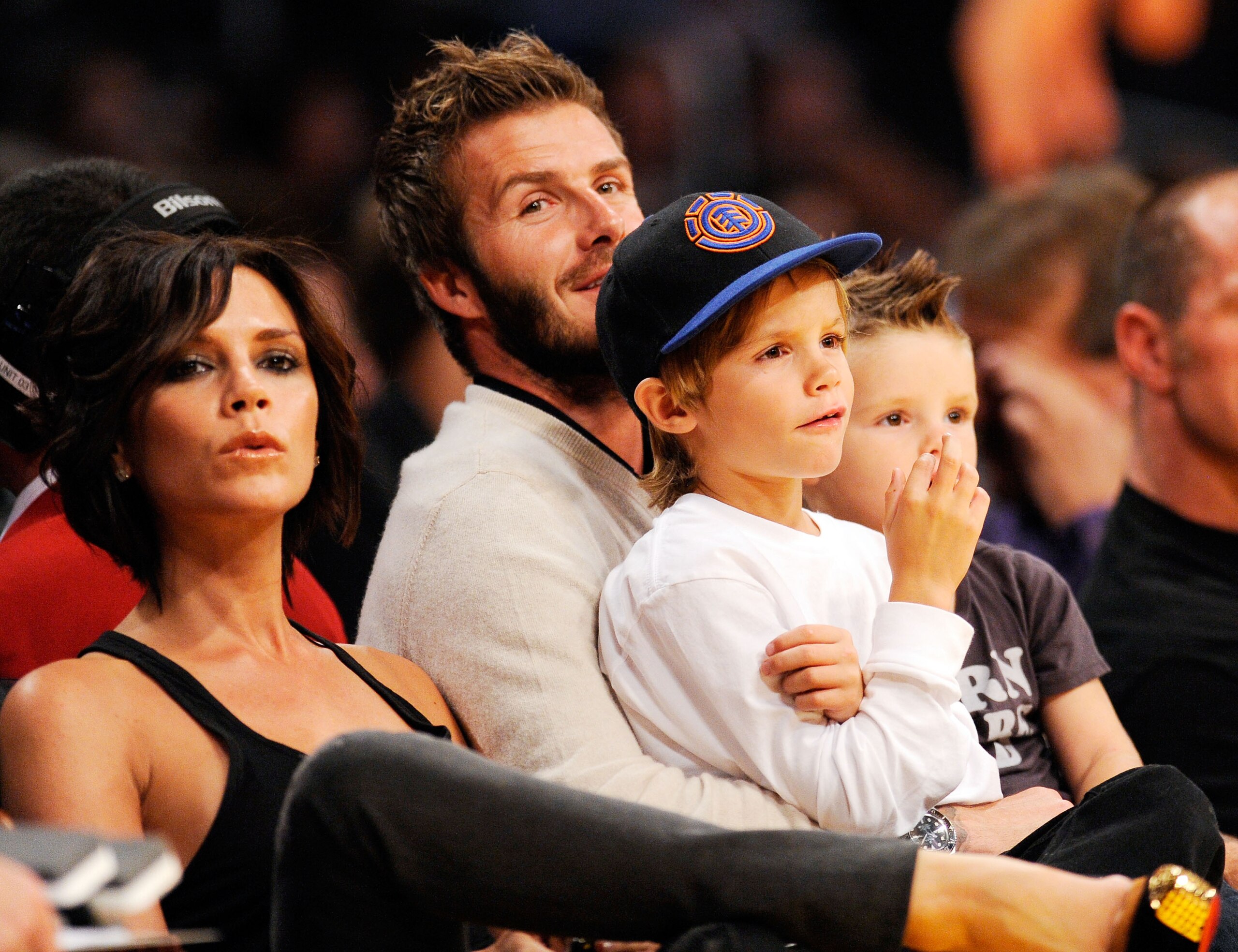 LOS ANGELES, CA - OCTOBER 30:  David Beckham and his wife Victoria follow the action between the Los Angeles Lakers and  the Dallas Mavericks along with their children Cruz, left, and Romeo, center right, at Staples Center on October 30, 2009 in Los Angel