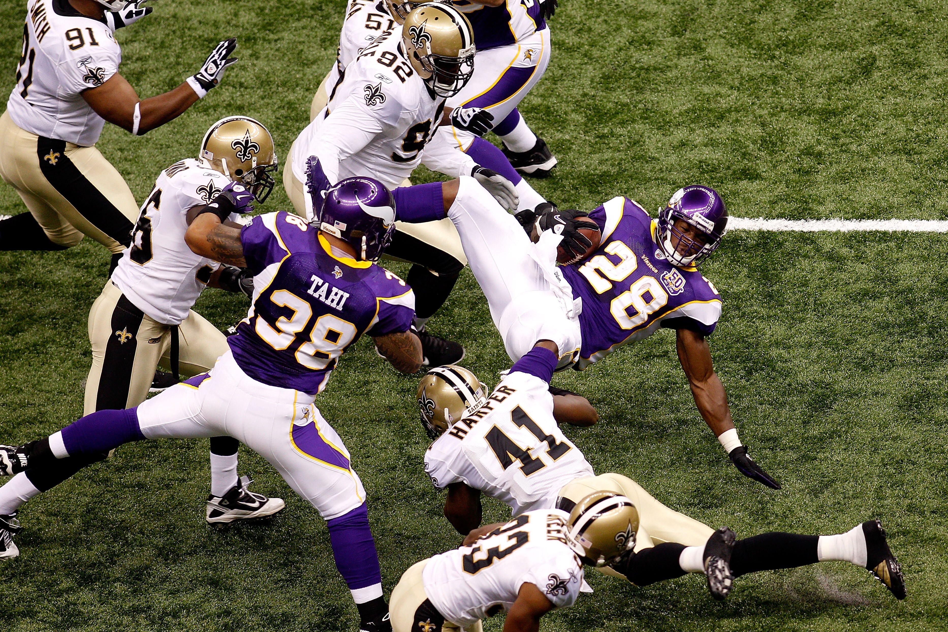 NEW ORLEANS - SEPTEMBER 09:  Adrian Peterson #28 of the Minnesota Vikings is tackled by Roman Harper #41 of the New Orleans Saints at Louisiana Superdome on September 9, 2010 in New Orleans, Louisiana.  (Photo by Chris Graythen/Getty Images)