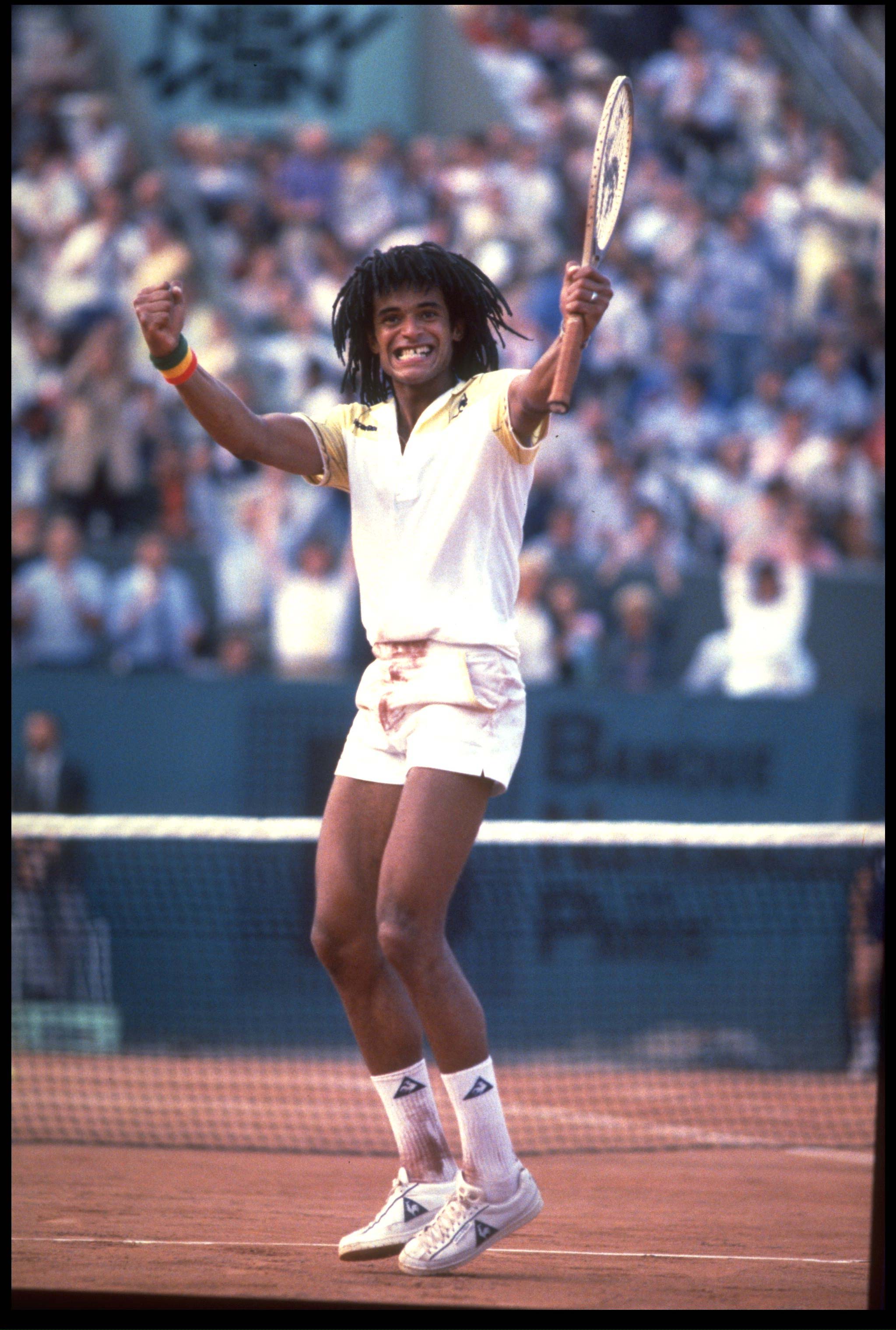 JUN 1983:  YANNICK NOAH OF FRANCE CELEBRATES AFTER WNNING THE MEN's SINGLES TITLE AT THE 1983 FRENCH OPEN GRAND SLAM.