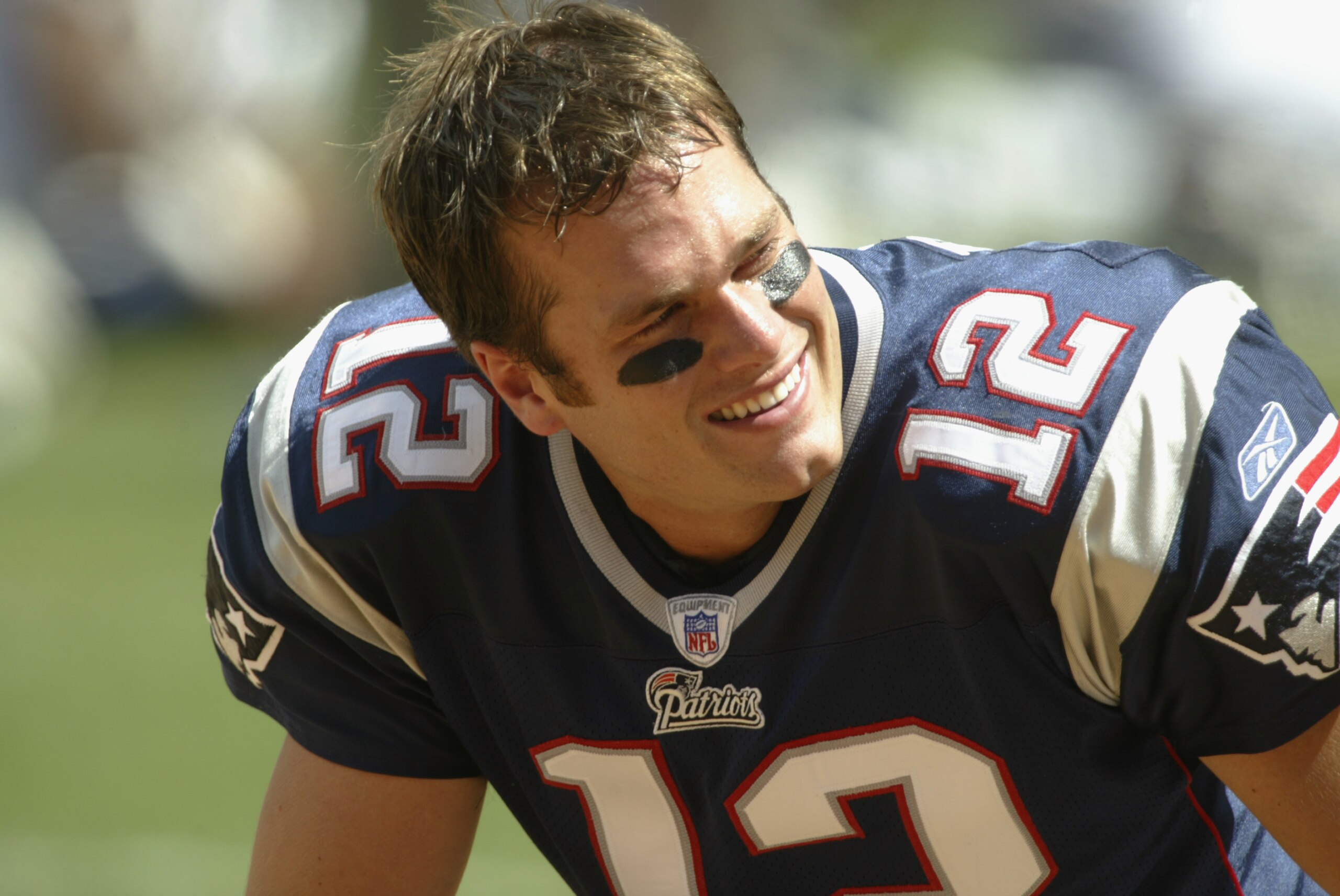 SAN DIEGO - SEPTEMBER 29:  Quarterback Tom Brady #12 of the New England Patriots kneels on the field before the NFL game against the San Diego Chargers on September 29, 2002 at Qualcomm Stadium in San Diego, California.  The Chargers won 21-14. (Photo by