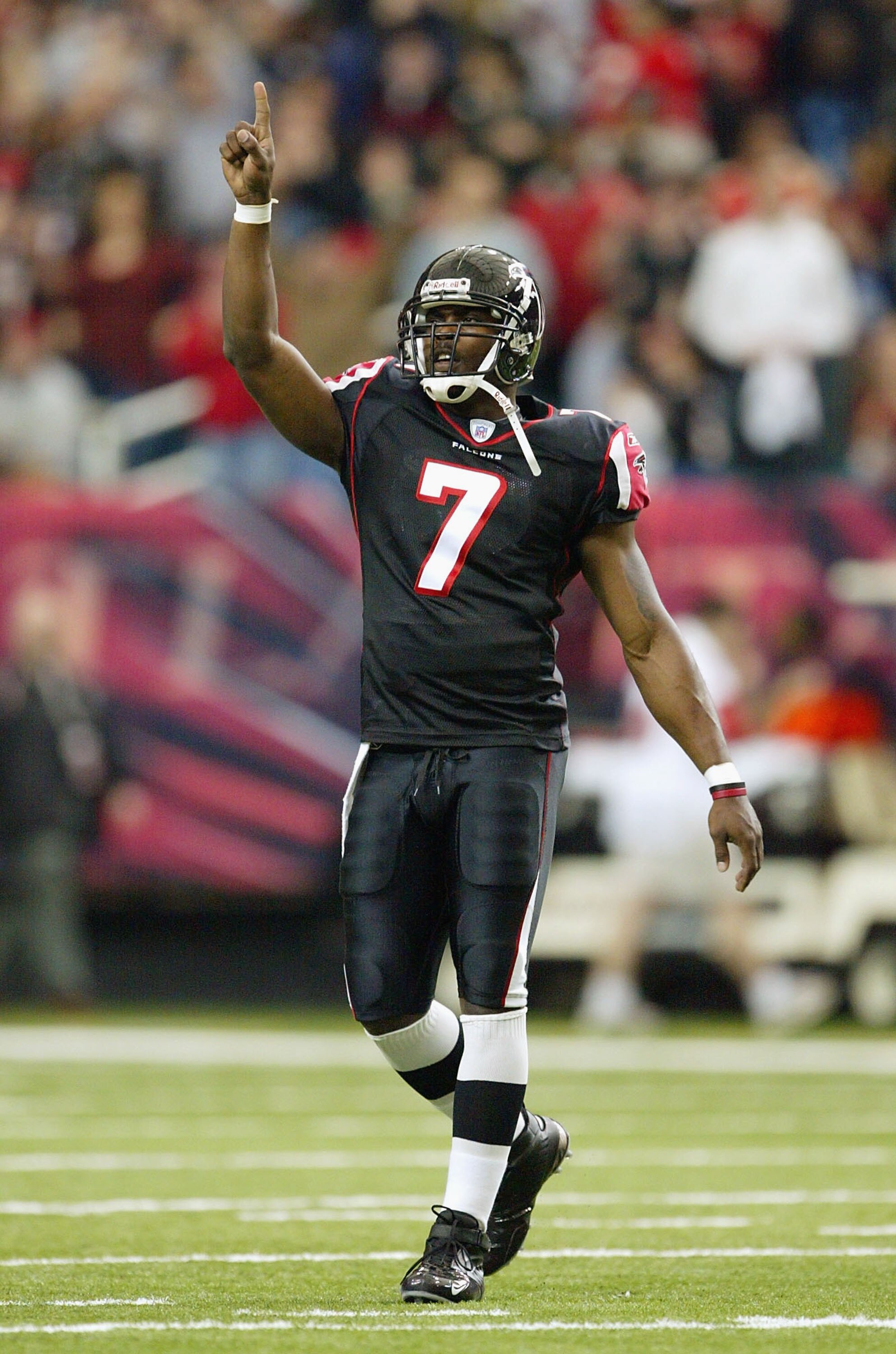 ATLANTA - DECEMBER 28:  Quarterback Michael Vick #7 of the Atlanta Falcons celebrates after throwing a touchdown pass to Peerless Price #81 against the Jacksonville Jaguars on December 28, 2003 at the Georgia Dome in Atlanta, Georgia.  (Photo by Jamie Squ