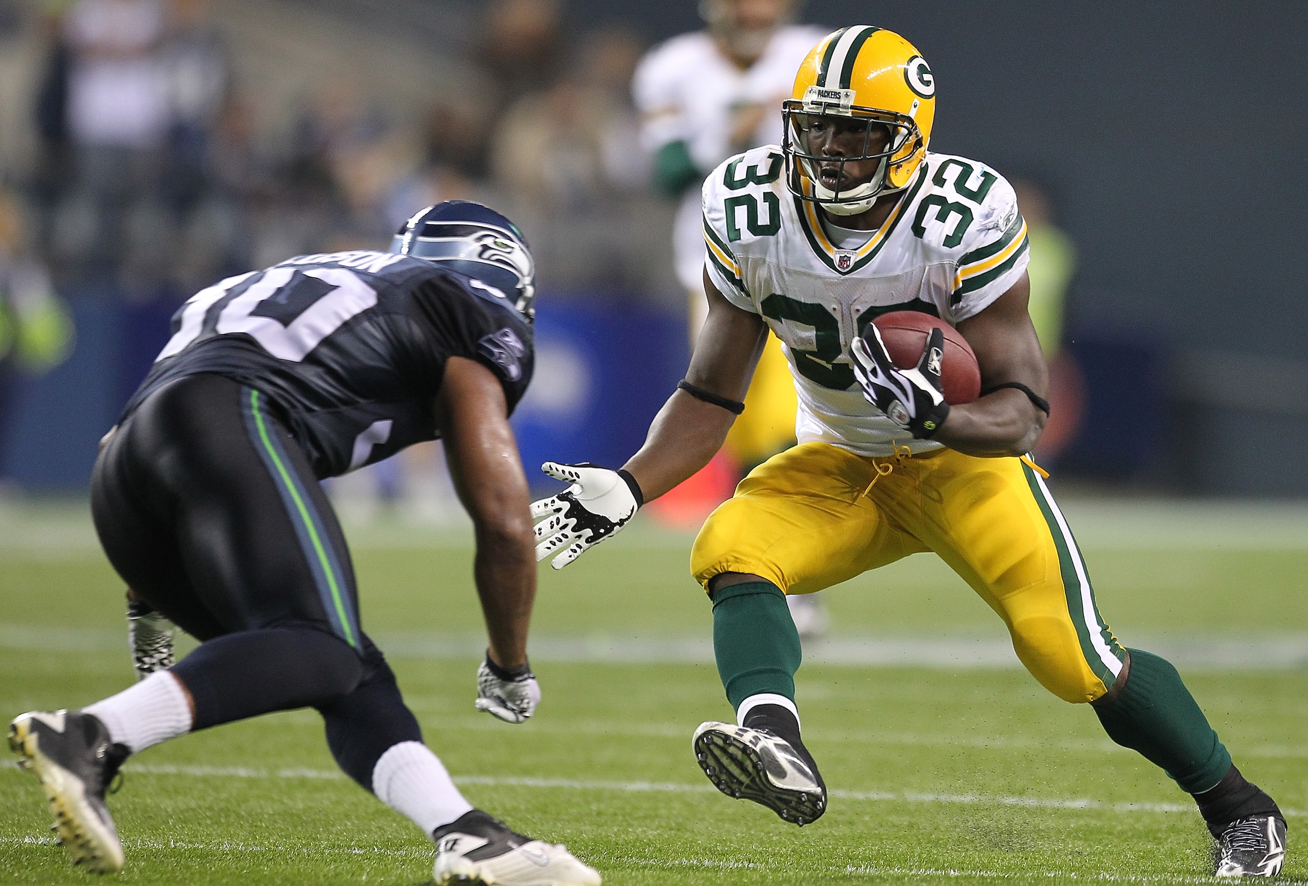 SEATTLE - AUGUST 21:  Running back Brandon Jackson #32 of the Green Bay Packers rushes during the preseason game against Kevin Ellison #30 of the Seattle Seahawks at Qwest Field on August 21, 2010 in Seattle, Washington. (Photo by Otto Greule Jr/Getty Ima