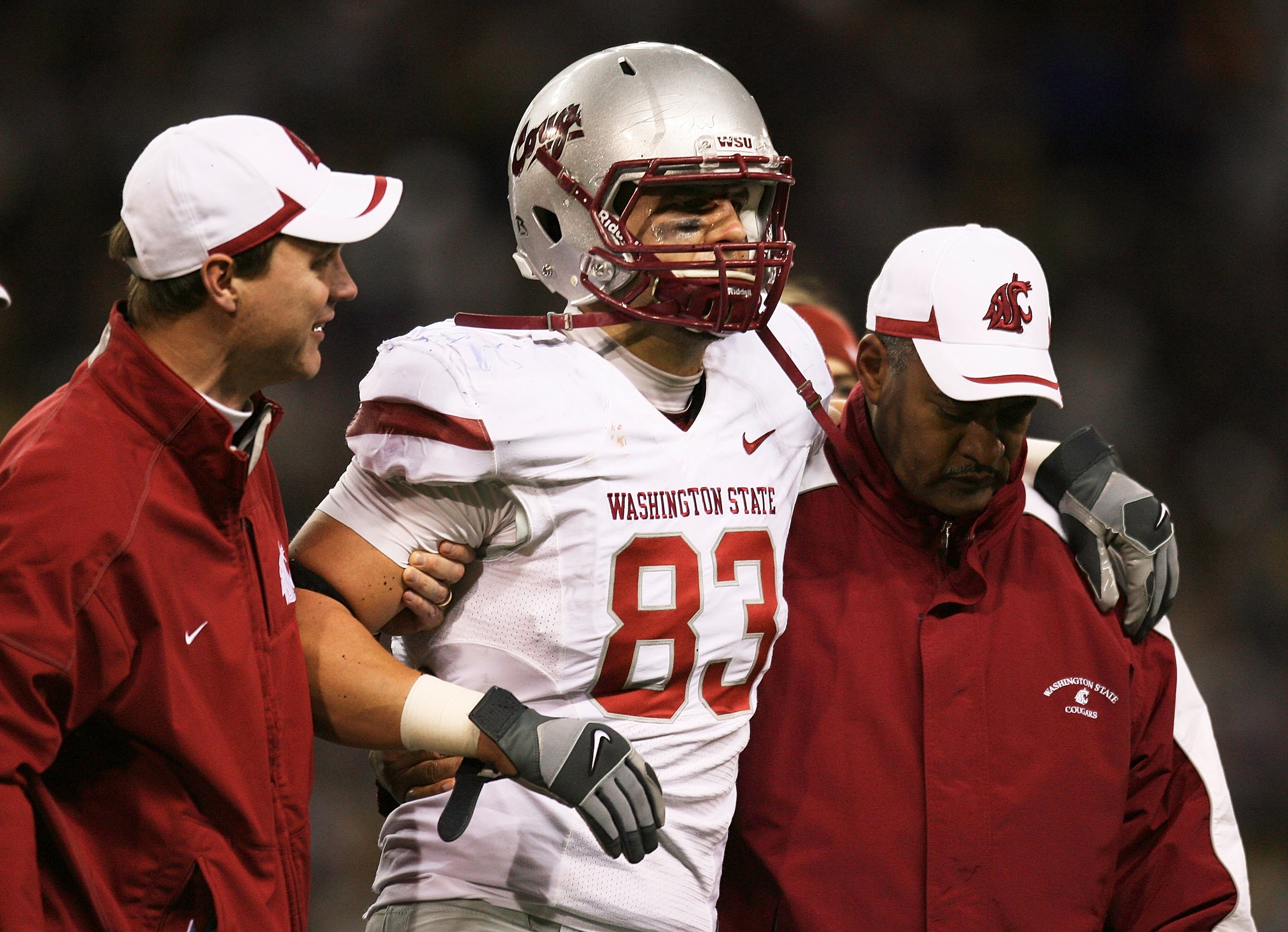 SEATTLE - NOVEMBER 28:  Tight end Zach Tatman #83 of the Washington State Cougars is helped off the field after being injured against the Washington Huskies on November 28, 2009 at Husky Stadium in Seattle, Washington. The Huskies defeated the Cougars 30-