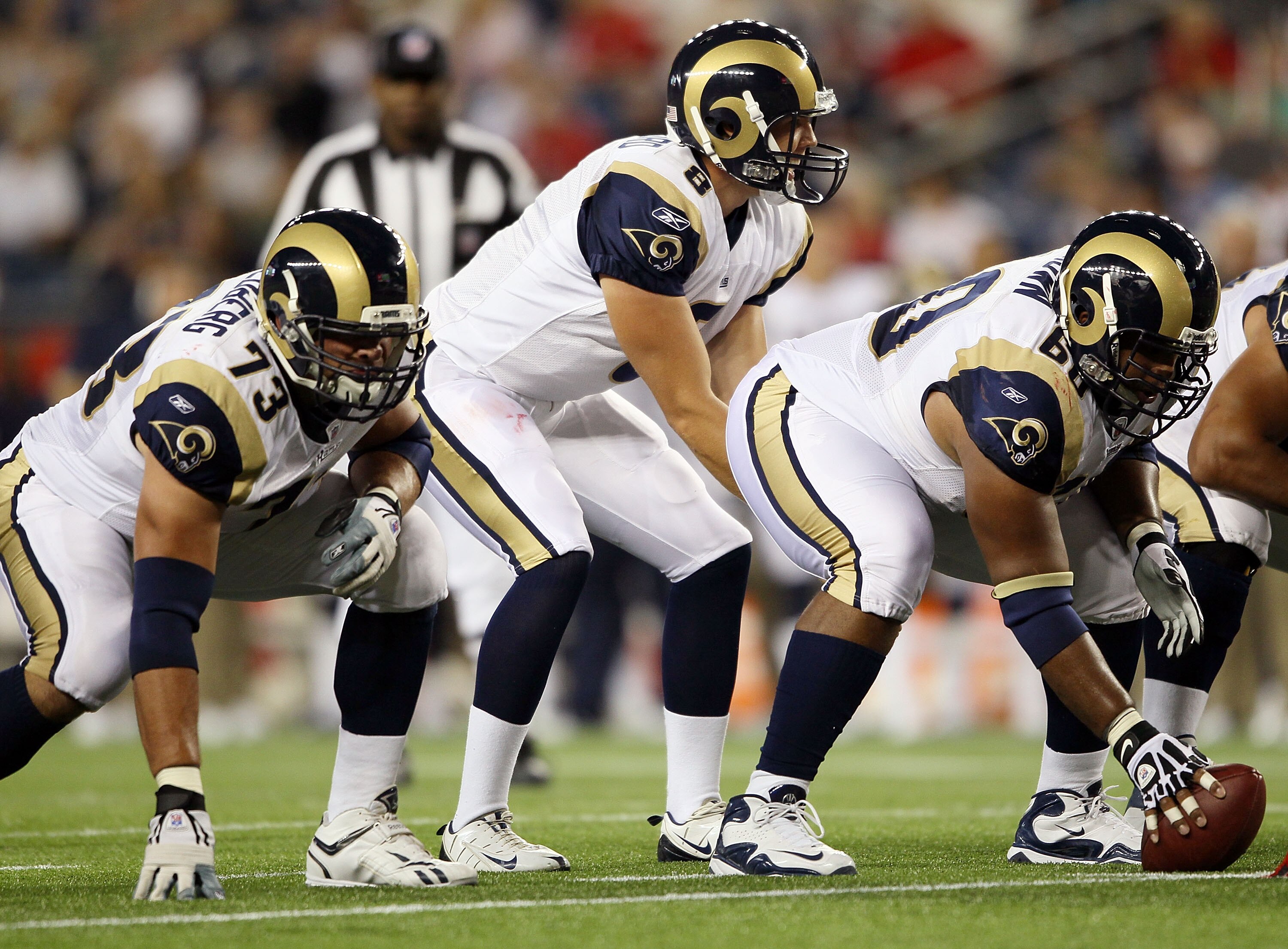 FOXBORO, MA - AUGUST 26:  Sam Bradford #8 of the St. Louis Rams calls out the play as Jason Brown #60 and Adam Goldberg #73 wait in the first half against the New England Patriots on August 26, 2010 at Gillette Stadium in Foxboro, Massachusetts.  (Photo b