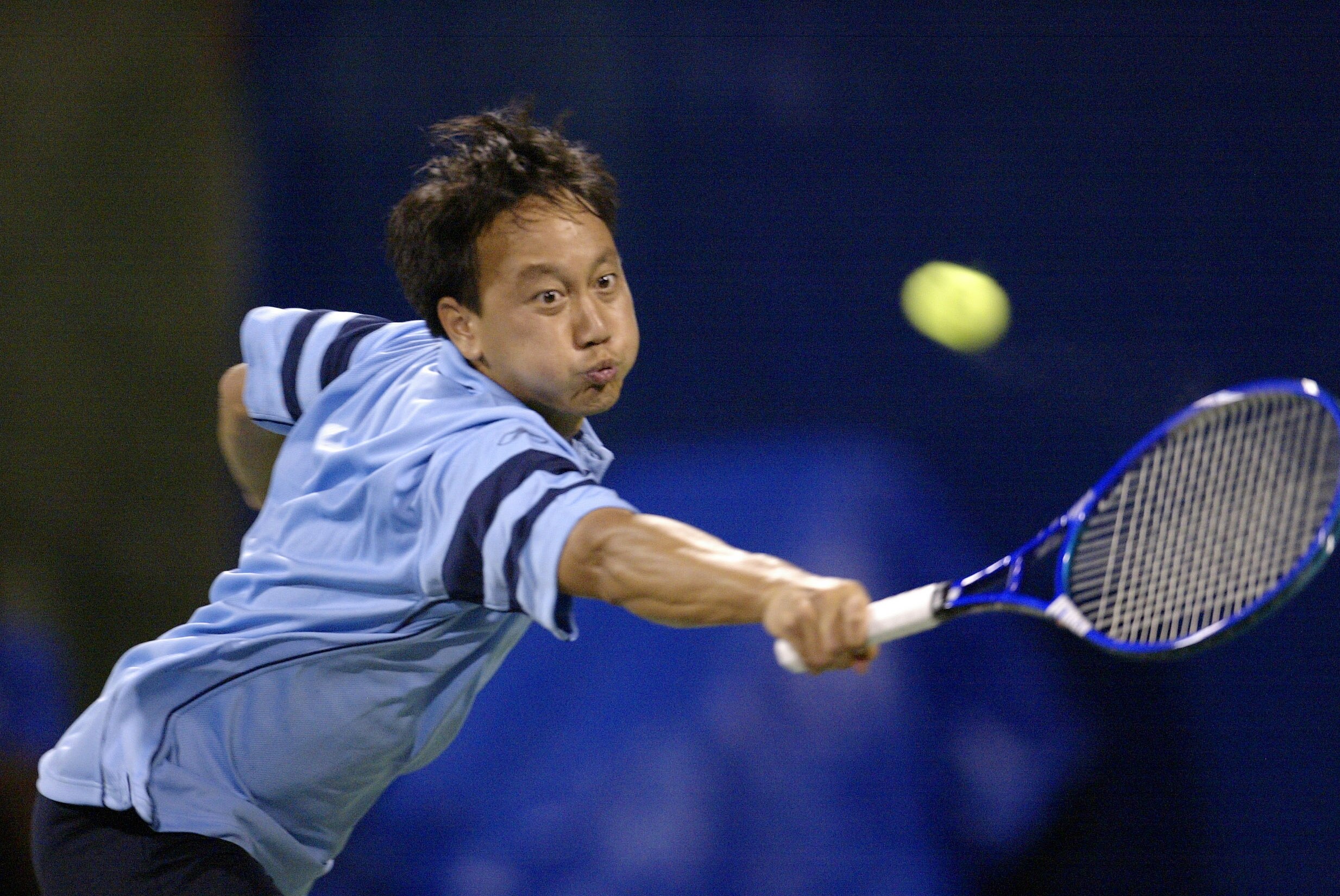 INDIANAPOLIS - JULY 21:  Michael Chang stretches out to return a serve at the baseline against Eric Taino during the RCA Championships at the Indianapolis Tennis Center July 21, 2003 in Indianapolis, Indiana.  Taino won 3-6, 6-3, 7-5.  (Photo by Brian Bah