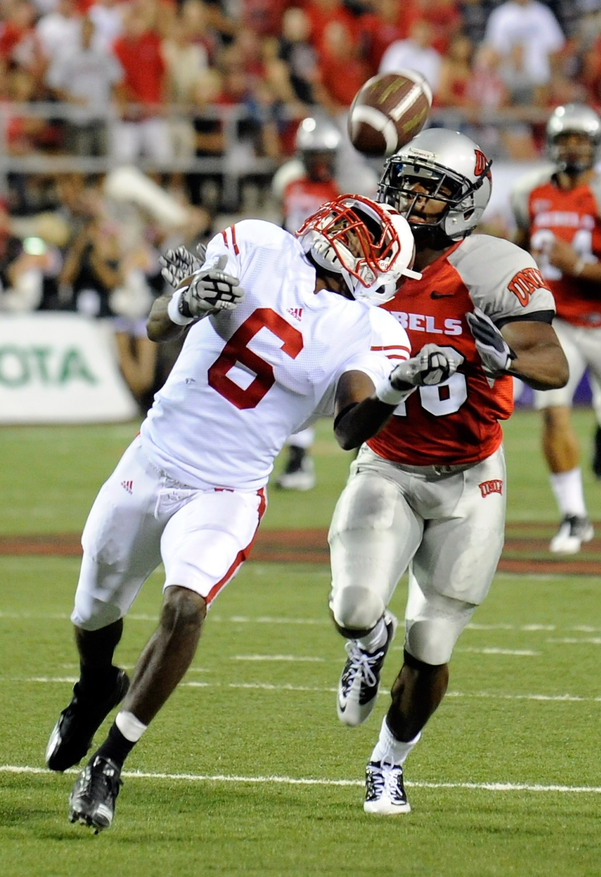 LAS VEGAS - SEPTEMBER 04:  Isaac Anderson #6 of the Wisconsin Badgers misses a catch in front of Deante' Purvis #26 of the UNLV Rebels during the first quarter of their game at Sam Boyd Stadium September 4, 2010 in Las Vegas, Nevada.  (Photo by Ethan Mill