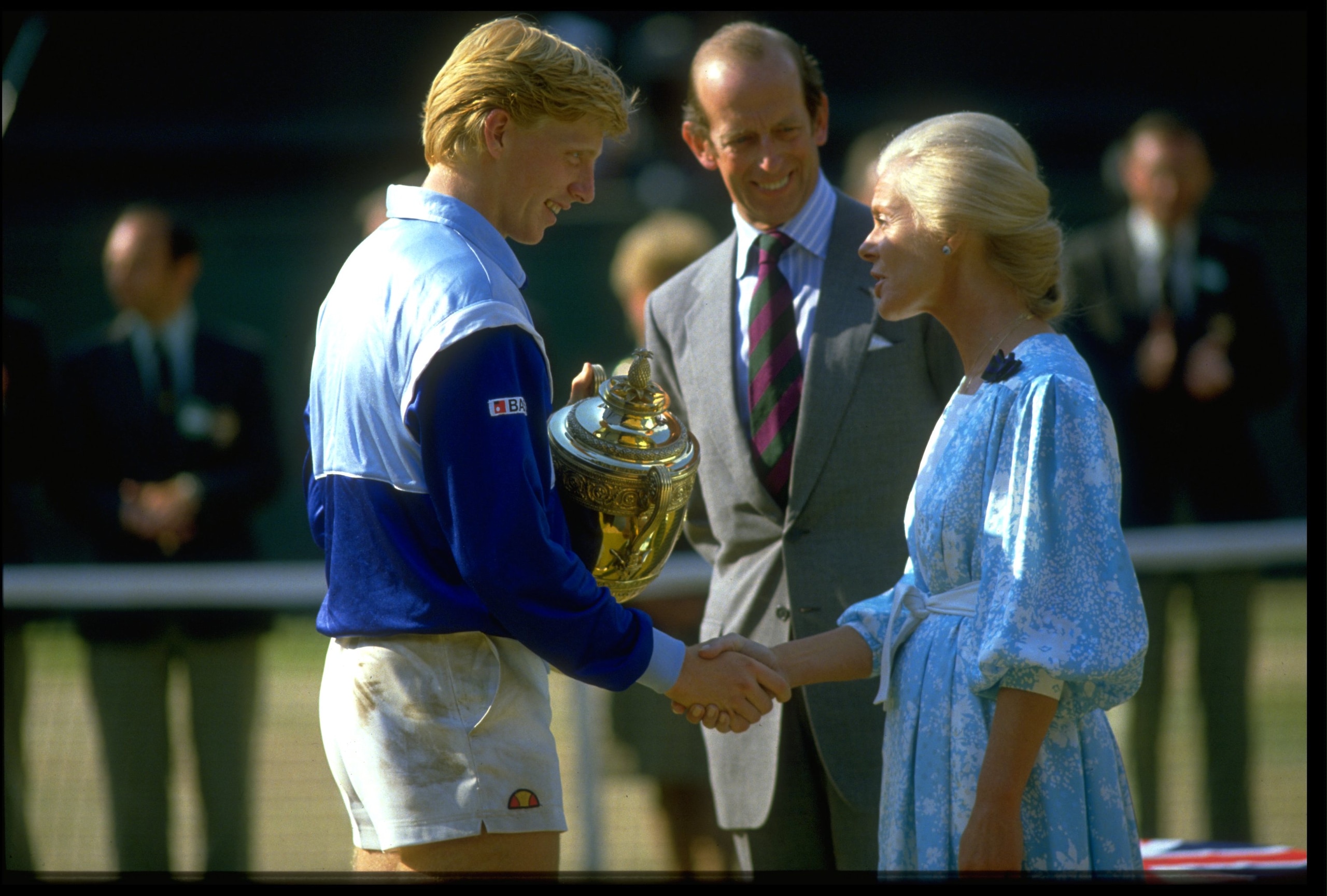 7 JUL 1985: BORIS BECKER OF WEST GERMANY RECEIVES THE TROPHY AFTER WINNING THE 1985 WIMBLEDON TENNIS CHAMPIONSHIPS. BECKER DEFEATED KEVIN CURREN 6-3, 6-7, 7-6, 6-4 TO BECOME THE YOUNGEST EVER MENS SINGLES CHAMPION. 7 JUL 1985: BORIS BECKER OF WEST GERMANY RECEIVES THE TROPHY AFTER WINNING THE 1985 WIMBLEDON TENNIS CHAMPIONSHIPS. BECKER DEFEATED KEVIN CURREN 6-3, 6-7, 7-6, 6-4 TO BECOME THE YOUNGEST EVER MENS SINGLES CHAMPION.