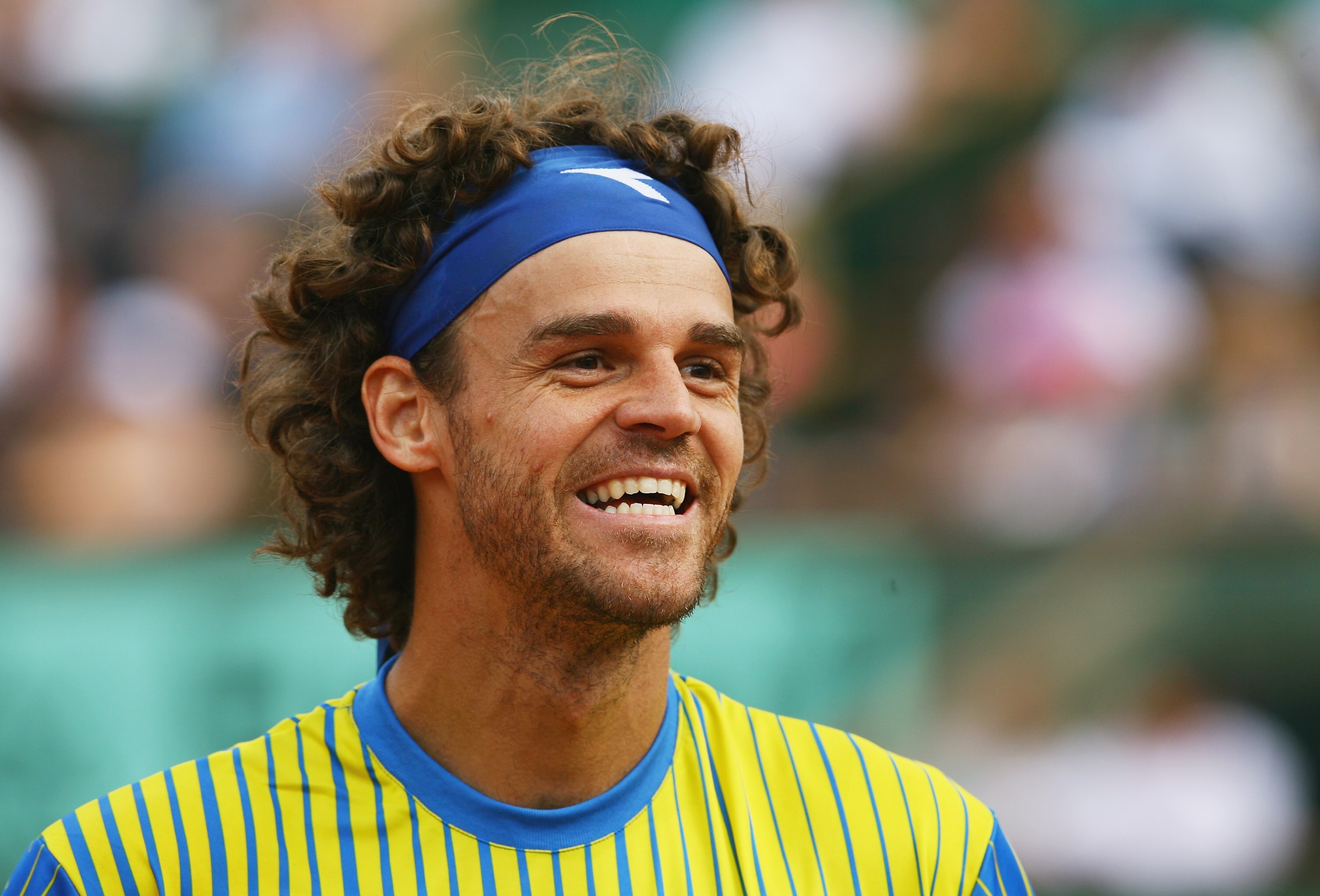PARIS - MAY 25:  Gustavo Kuerten of Brazil smiles at the fans after his career ending defeat during Men's Singles first round match against Paul-Henri Mathieu of France on day one of the French Open at Roland Garros on May 25, 2008 in Paris, France. The F