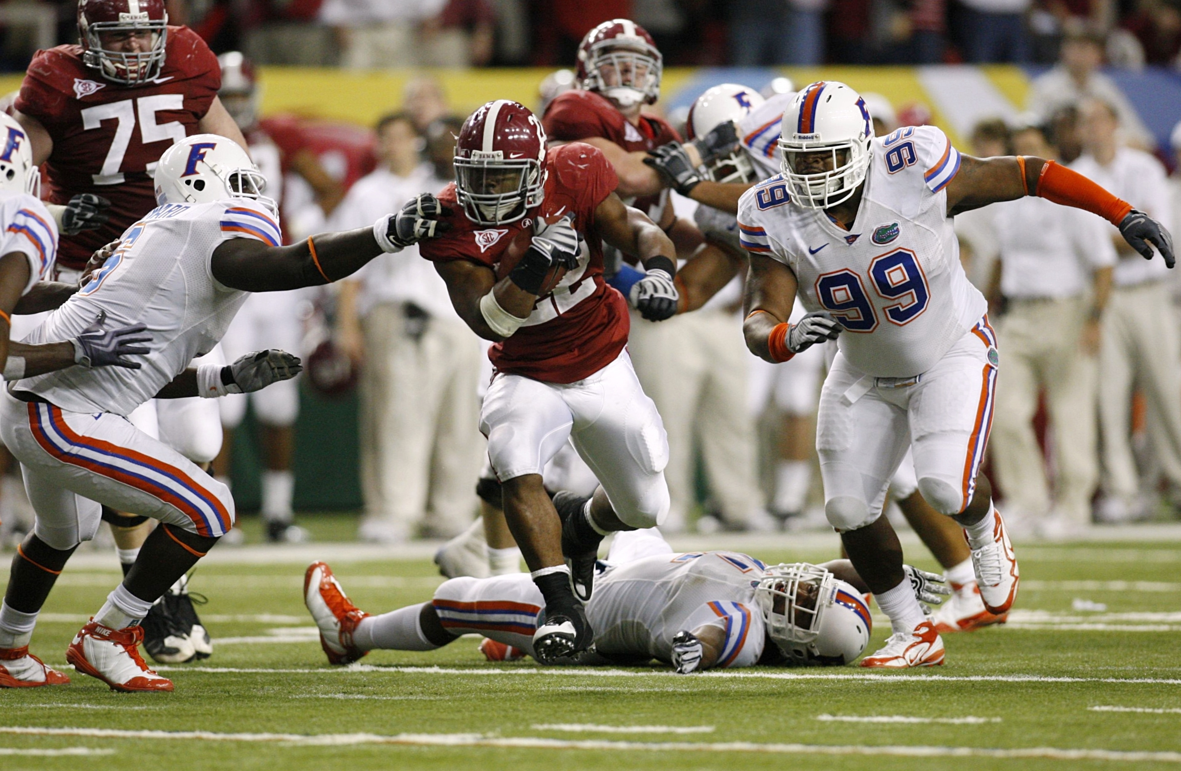 ATLANTA - DECEMBER 5:  Mark Ingram #22 of the Alabama Crimson Tide runs the ball against Omar Hunter #99 of the Florida Gators during the SEC Championship game at Georgia Dome on December 5, 2009 in Atlanta, Georgia. Alabama won 32-13. (Photo by Chris Gra