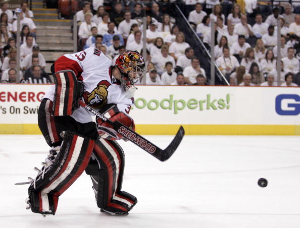 PITTSBURGH - APRIL 22:  Pascal Leclaire #33 of the Ottawa Senators clears a puck against the Pittsburgh Penguins in Game Five of the Eastern Conference Quarterfinals during the 2010 NHL Stanley Cup Playoffs at Mellon Arena on April 22, 2010 in Pittsburgh,