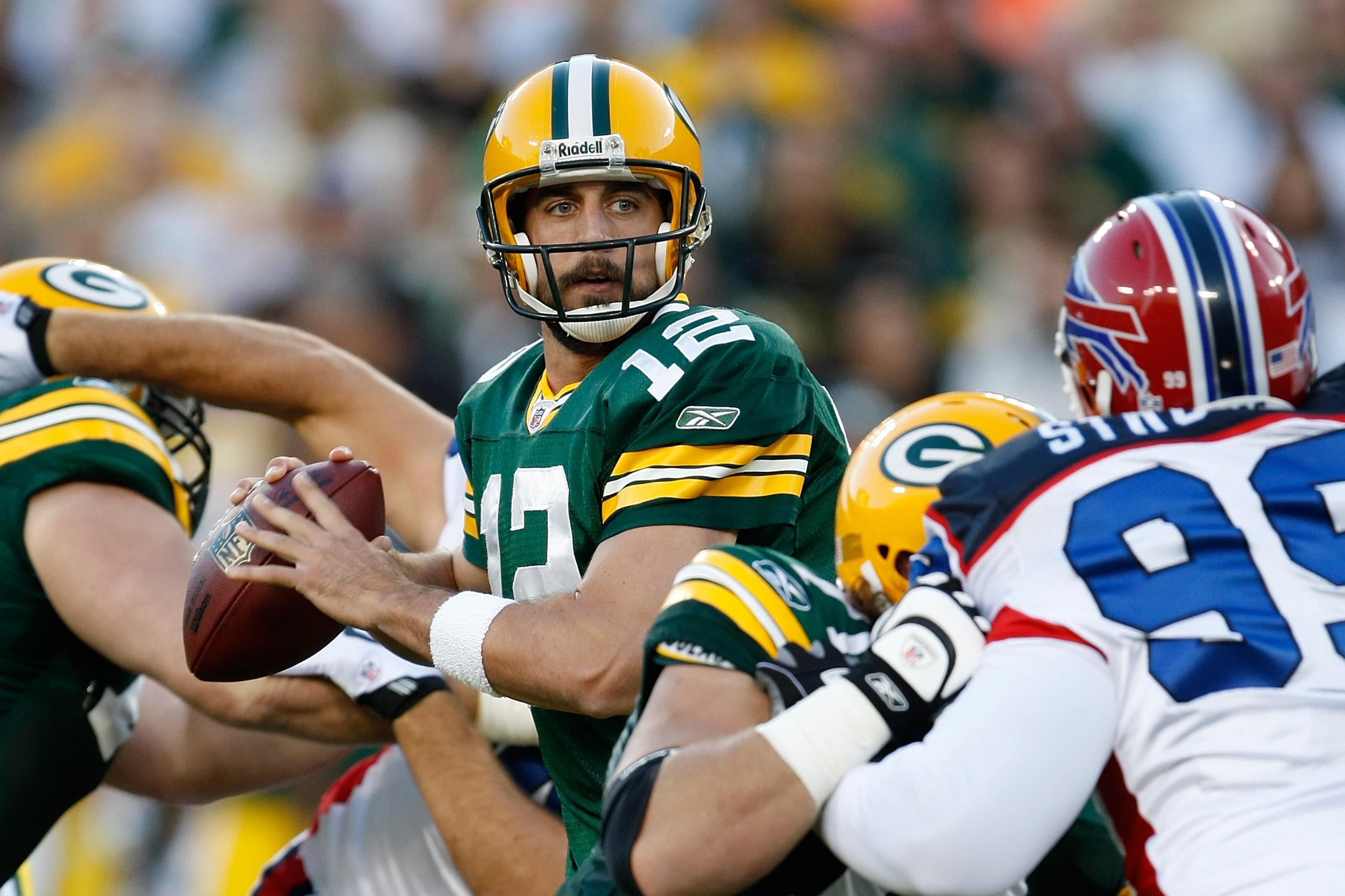 GREEN BAY, WI - AUGUST 22: Quarterback Aaron Rogers #12 of the Green Bay Packers drops back to pass the football against the Buffalo Bills at Lambeau Field on August 22, 2009 in Green Bay. Wisconsin.  (Photo by Scott Boehm/Getty Images)