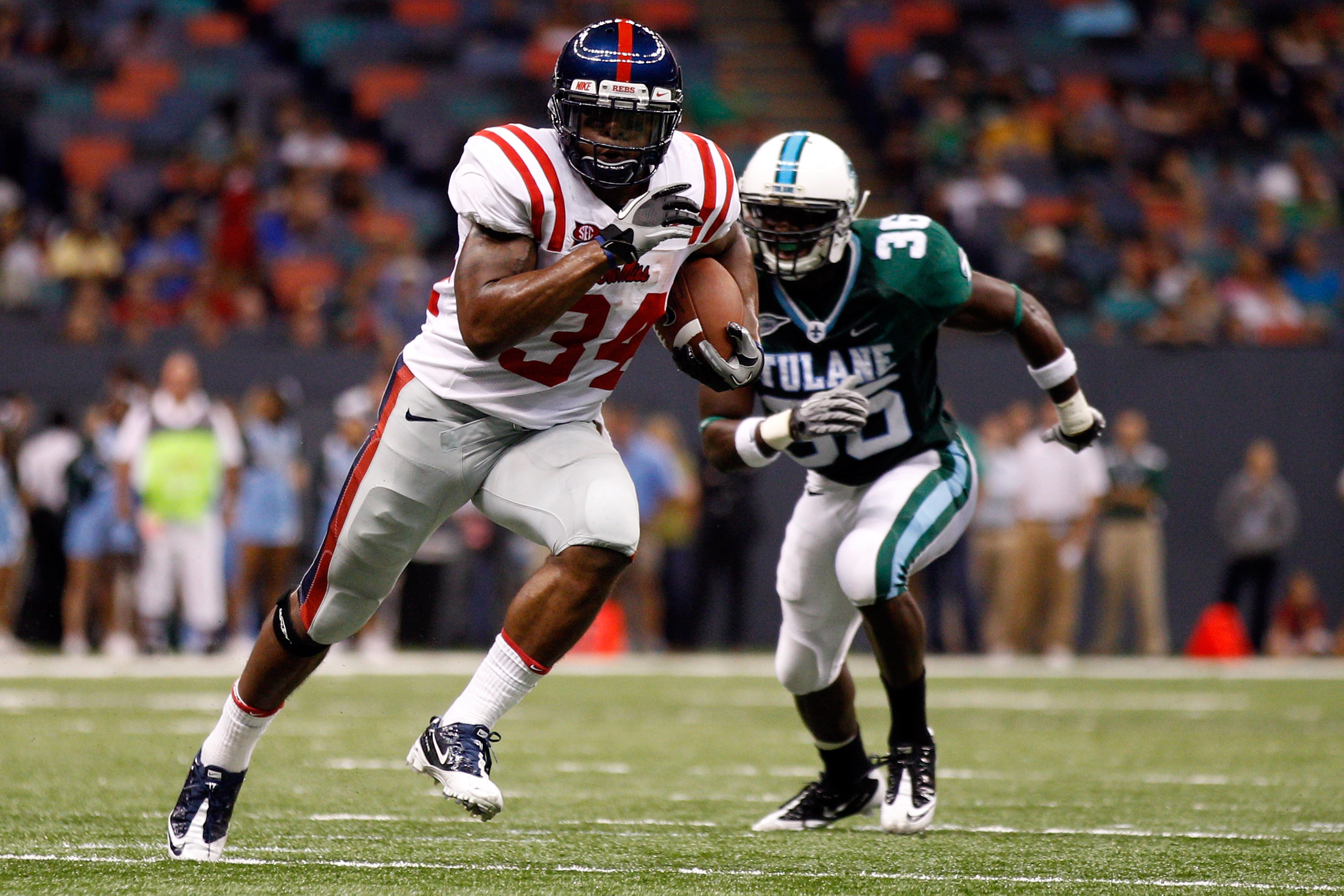 NEW ORLEANS - SEPTEMBER 11:  Brandon Bolden #34 of the Ole Miss Rebels runs past Dominique Robertson #36 of the Tulane Green Wave at the Louisiana Superdome on September 11, 2010 in New Orleans, Louisiana.  (Photo by Chris Graythen/Getty Images)