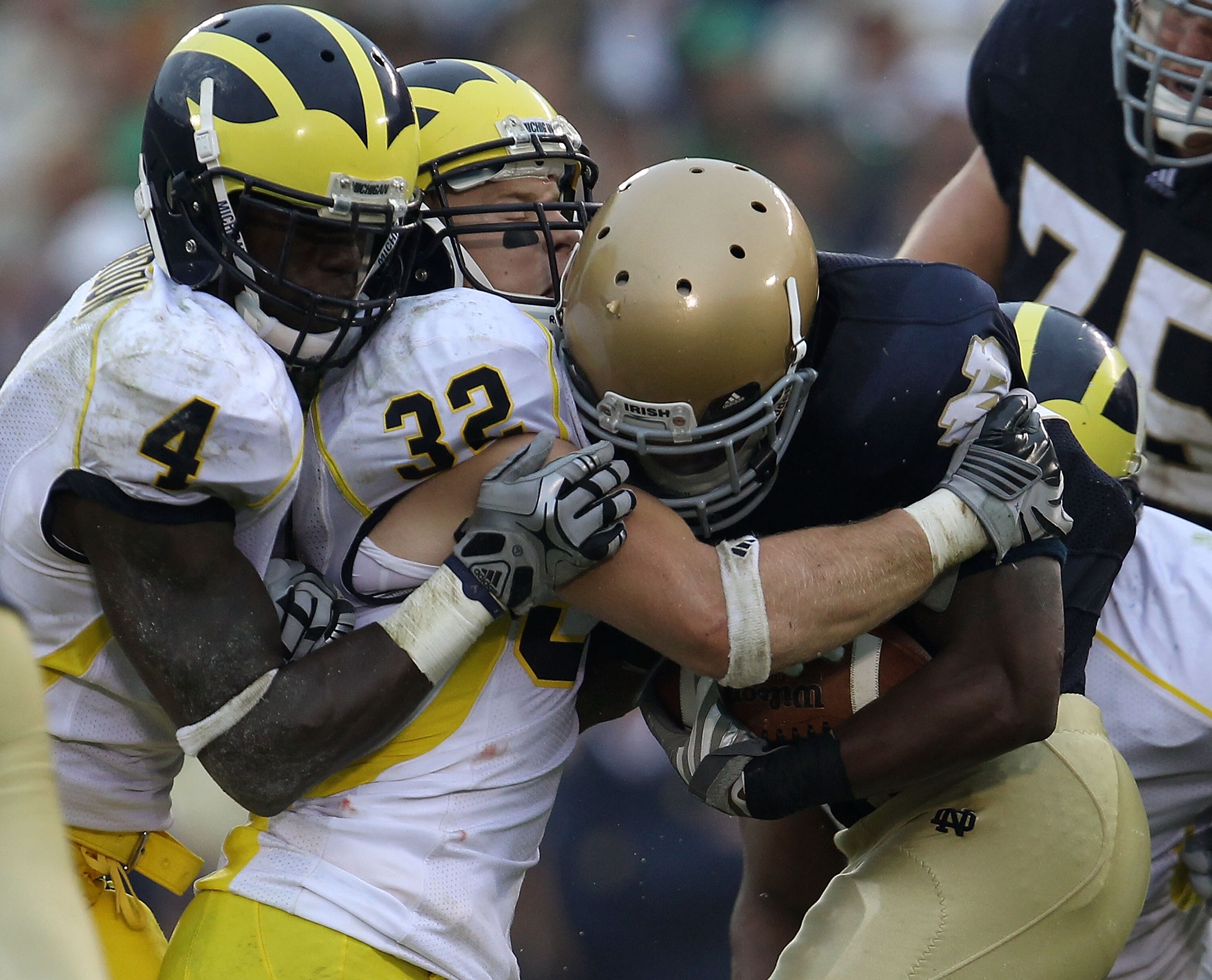 SOUTH BEND, IN - SEPTEMBER 11: Armando Allen, Jr. #5 of the Notre Dame Fighting Irish is stopped by Cameron Gordon #4 and Jordan Kovacs #32 of the Michigan Wolverines at Notre Dame Stadium on September 11, 2010 in South Bend, Indiana. Michigan defeated No SOUTH BEND, IN - SEPTEMBER 11: Armando Allen, Jr. #5 of the Notre Dame Fighting Irish is stopped by Cameron Gordon #4 and Jordan Kovacs #32 of the Michigan Wolverines at Notre Dame Stadium on September 11, 2010 in South Bend, Indiana. Michigan defeated No