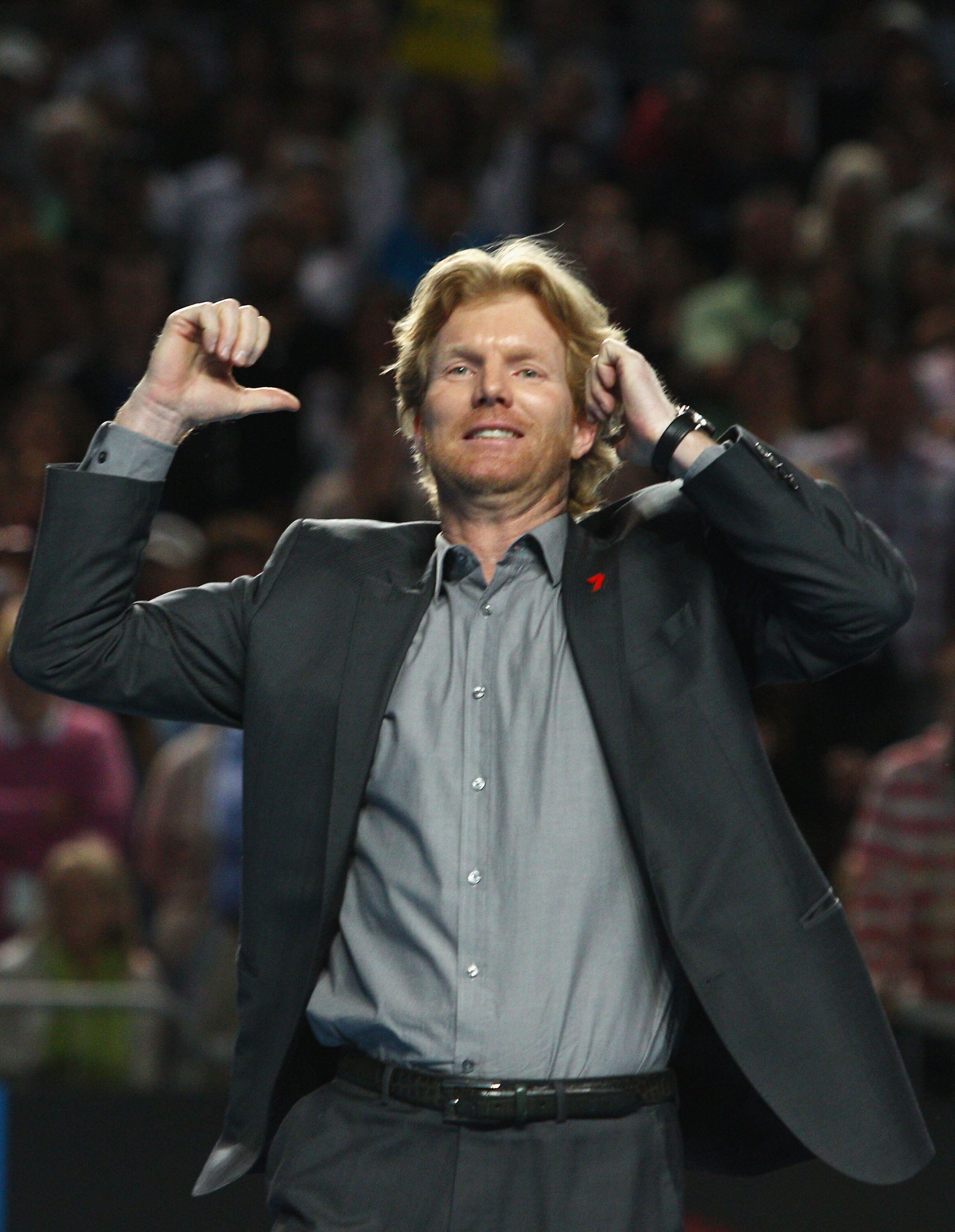 MELBOURNE, AUSTRALIA - JANUARY 23:  Former tennis player Jim Courier impersonates Jo-Wilfried Tsonga of France after his third round match win against Tommy Haas of Germany during day six of the 2010 Australian Open at Melbourne Park on January 23, 2010 i