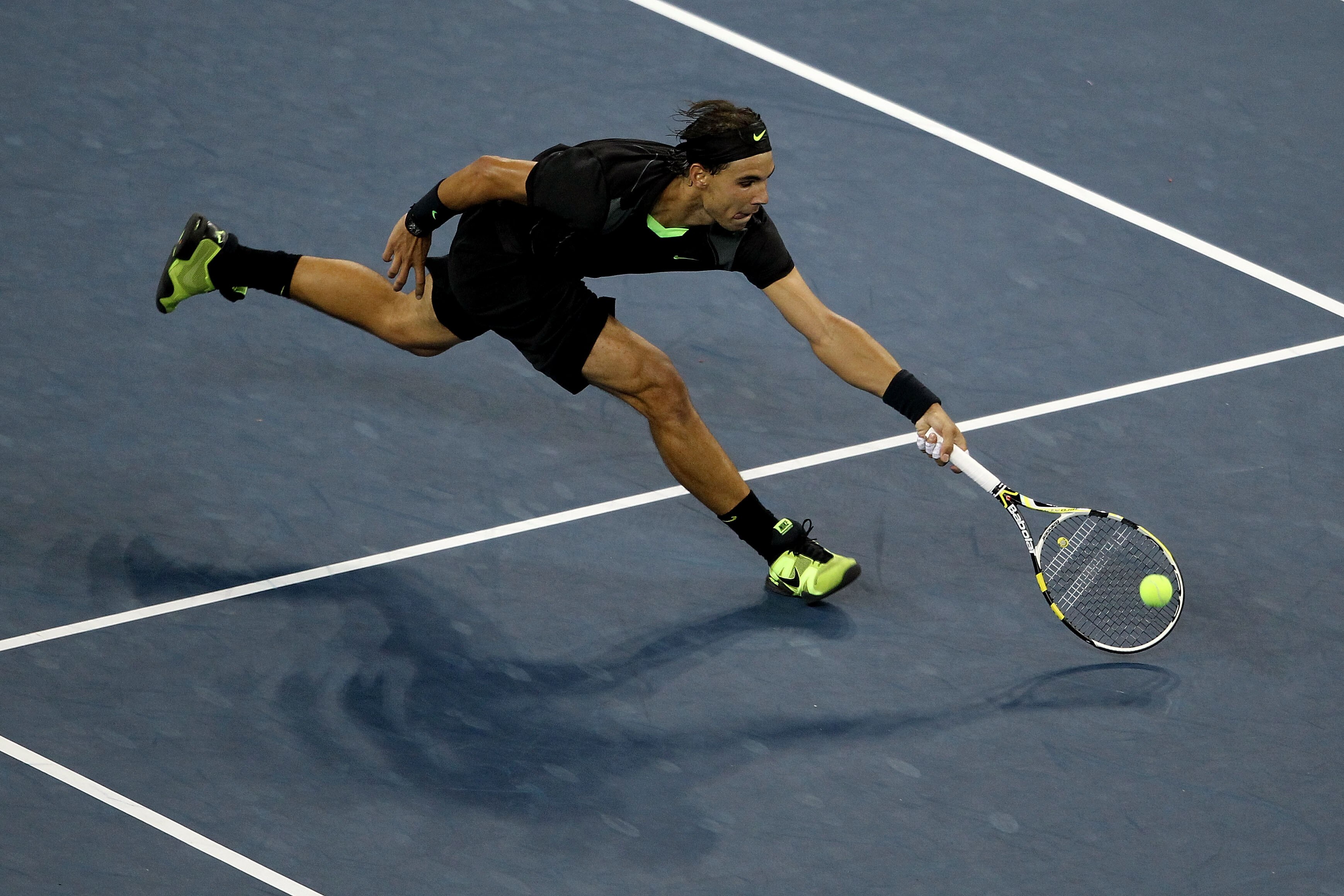 NEW YORK - SEPTEMBER 13:  Rafael Nadal of Spain returns a shot against Novak Djokovic of Serbia during his men's singles final match on day fifteen of the 2010 U.S. Open at the USTA Billie Jean King National Tennis Center on September 13, 2010 in the Flus