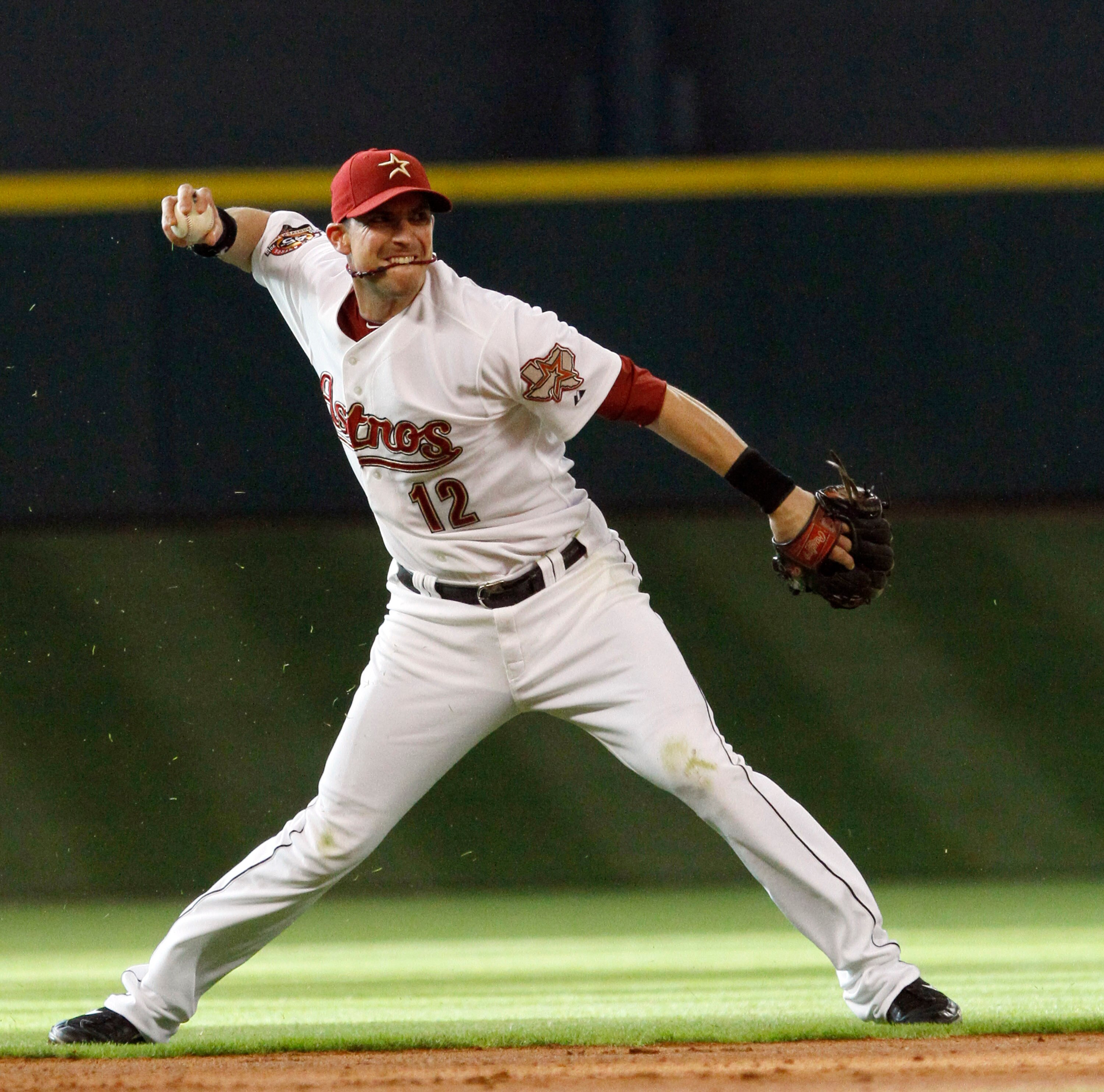 HOUSTON - JUNE 05:  Shortstop Tommy Manzella #12 of the Houston Astros throws to first base after making a diving stop on a ball hit up the middle against the Chicago Cubs at Minute Maid Park on June 5, 2010 in Houston, Texas.  (Photo by Bob Levey/Getty I