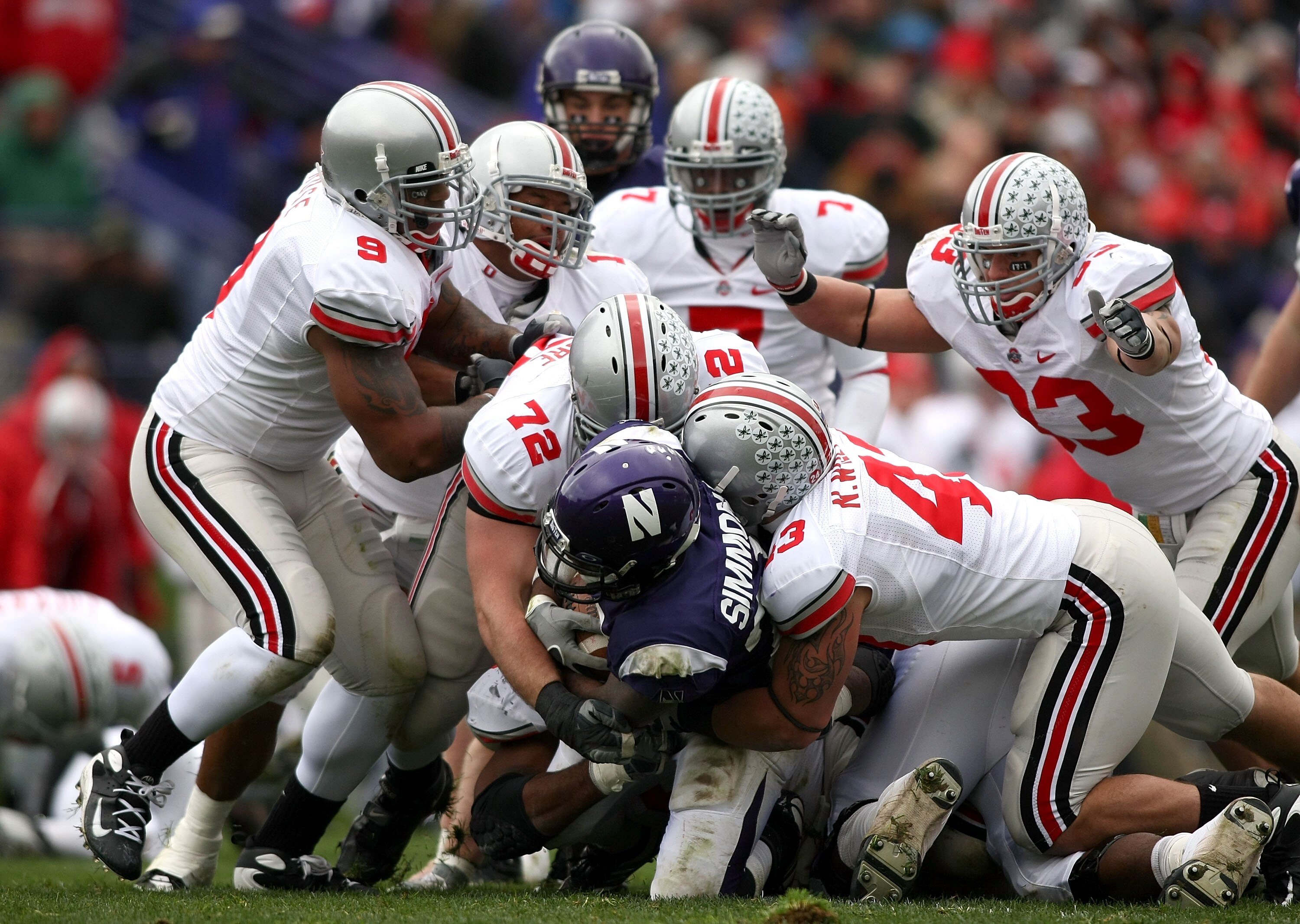 EVANSTON, IL - NOVEMBER 08:  Stephan Simmons #25 of the Northwestern Wildcats is tackled by Nate Williams #43 and Dexter Larimore #72 of the Ohio State Buckeyes at Ryan Stadium on November 8, 2008 in Evanston, Illinois  (Photo by Jonathan Ferrey/Getty Ima