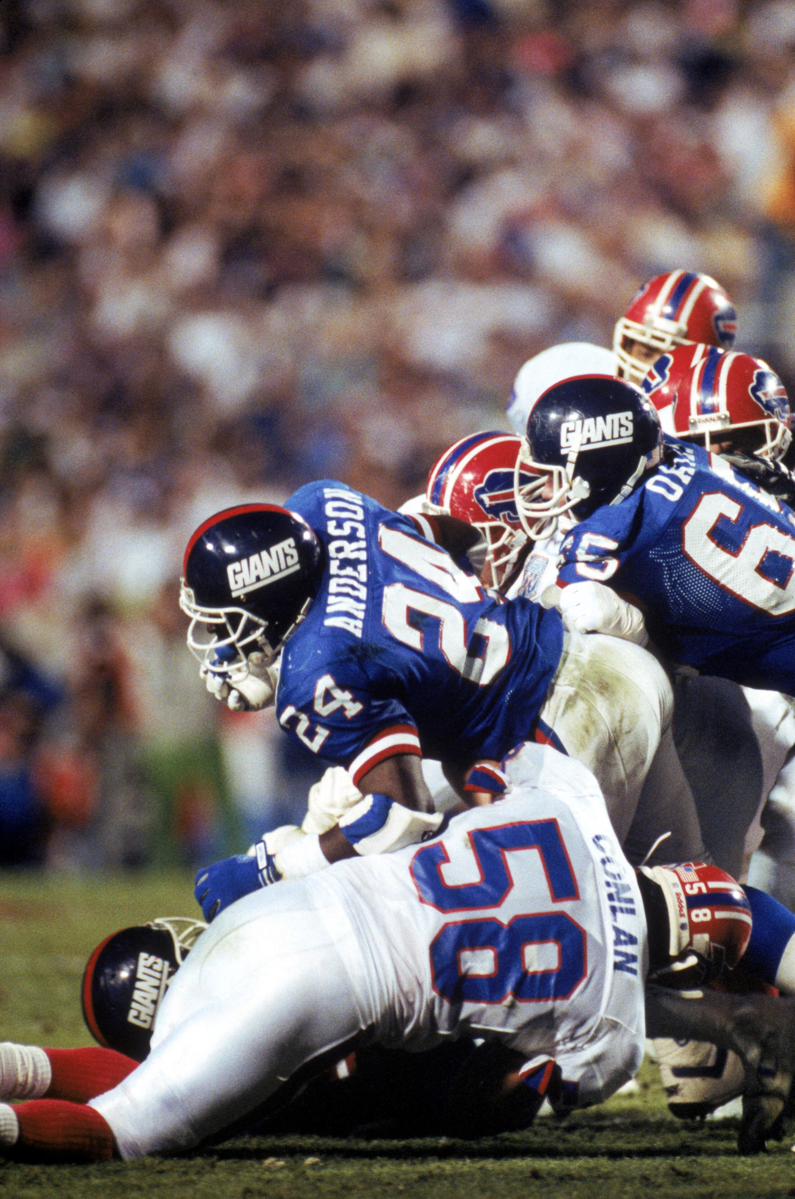TAMPA, FL - JANUARY 27: Running back Ottis Anderson #24 of the New York Giants fights for yardage against linebacker Shane Conlan #58 of the Buffalo Bills during Super Bowl XXV at Tampa Stadium on January 27, 1991 in Tampa, Florida. The Giants defeated t TAMPA, FL - JANUARY 27: Running back Ottis Anderson #24 of the New York Giants fights for yardage against linebacker Shane Conlan #58 of the Buffalo Bills during Super Bowl XXV at Tampa Stadium on January 27, 1991 in Tampa, Florida. The Giants defeated t