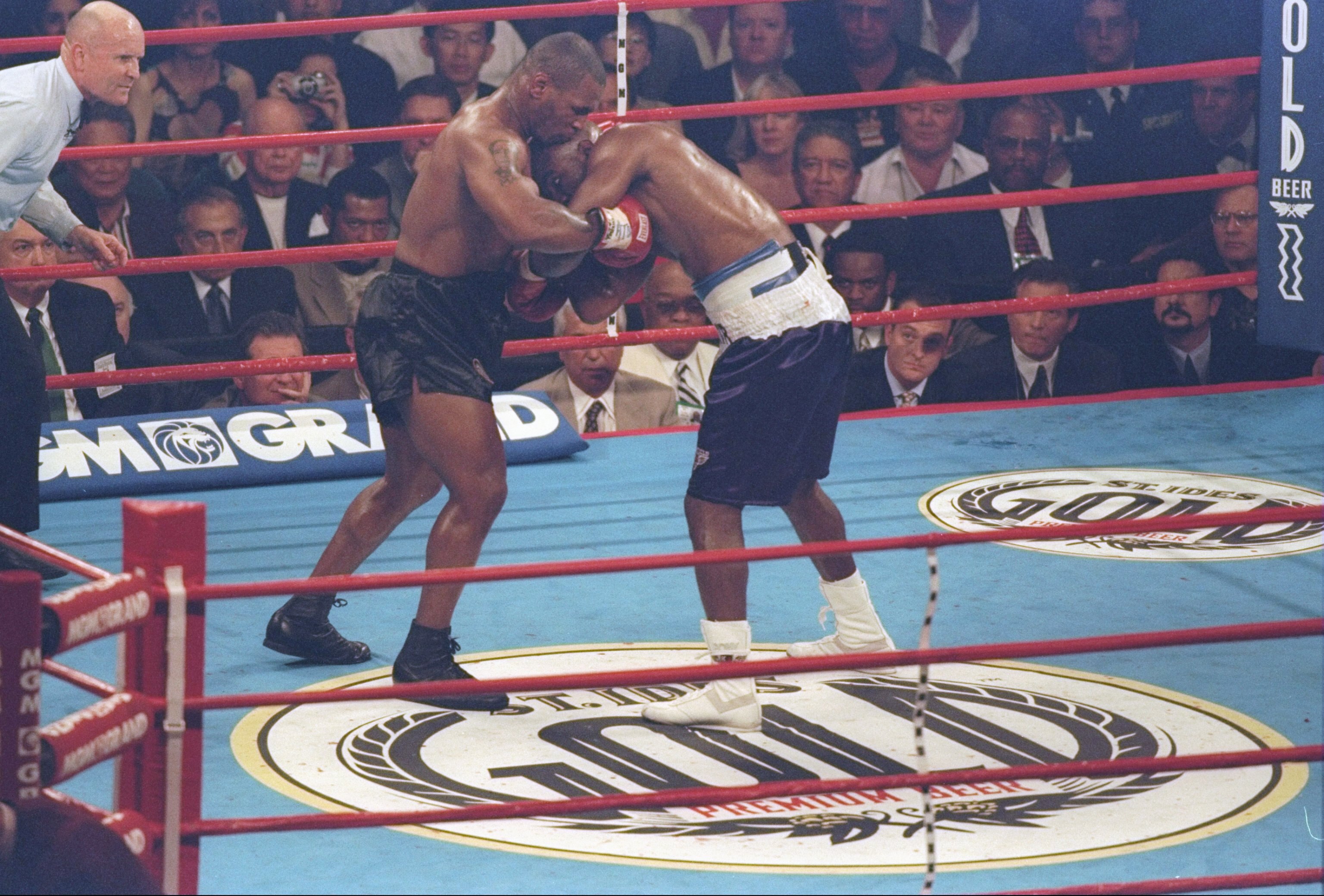 28 Jun 1997: Evander Holyfield and Mike Tyson lock arms during their heavyweight title bout at the MGM Grand Garden in Las Vegas, Nevada. Holyfield won the fight after Tyson was disqualified in the third round for biting Holyfield twice.