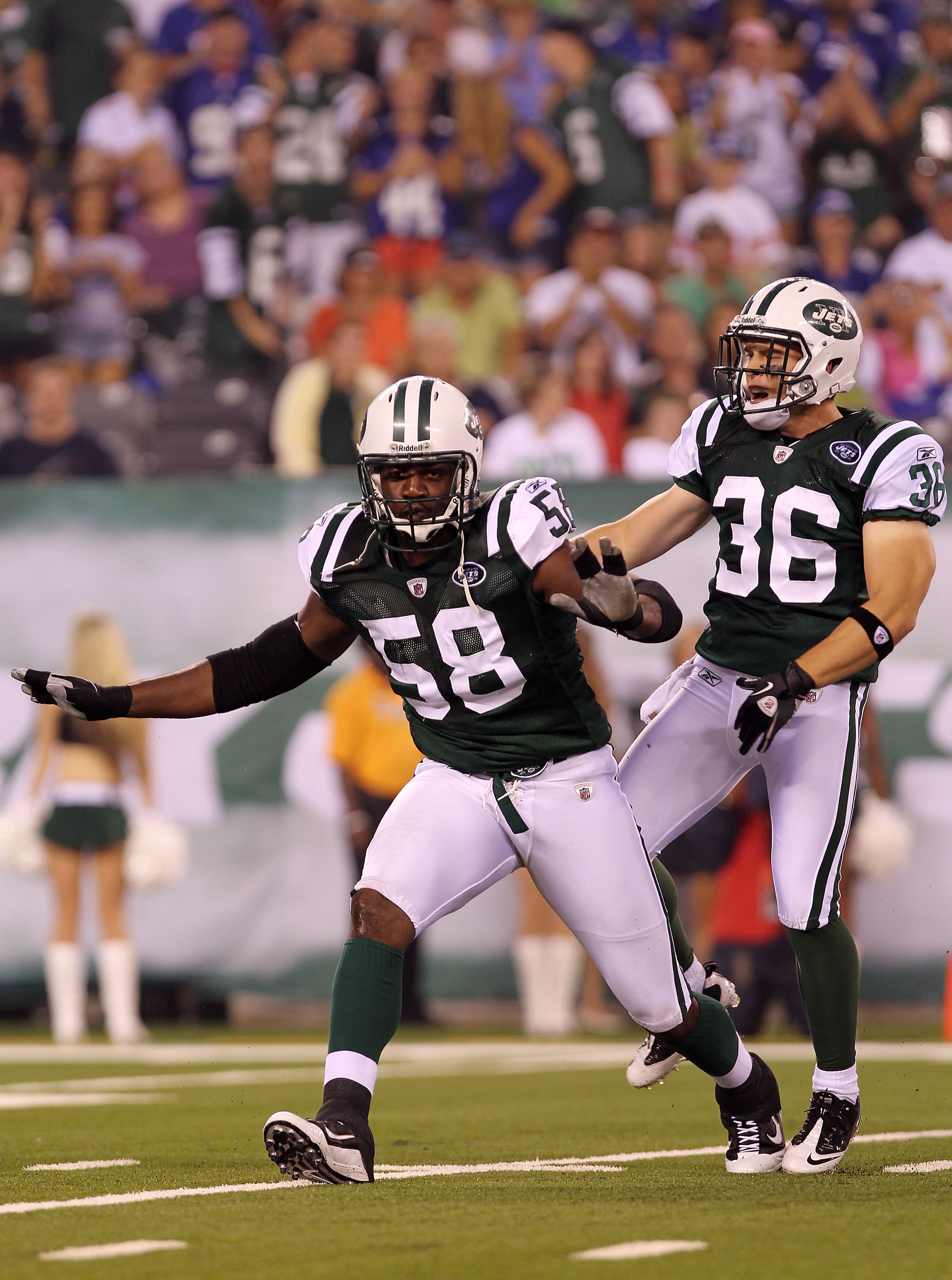 EAST RUTHERFORD, NJ - AUGUST 16:  Bryan Thomas #58 and Jim Leonhard #36 of the New York Jets celebrate a tackle against the New York Giants during their game at New Meadowlands Stadium on August 16, 2010 in East Rutherford, New Jersey.  (Photo by Nick Lah