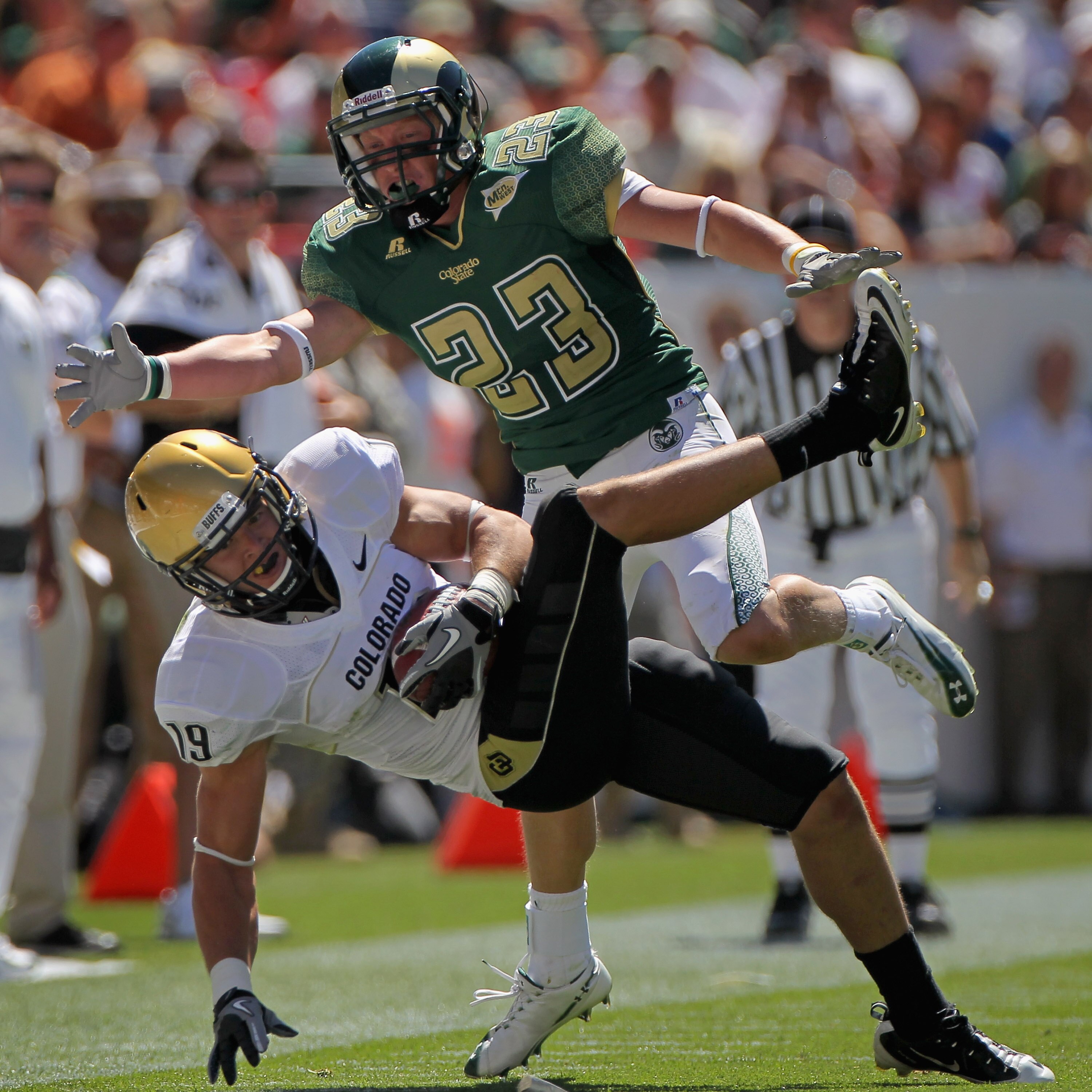 DENVER - SEPTEMBER 04:  Safety Travis Sandersfield #19 of the Colorado Buffaloes intercepts a pass intended for Tyson Liggett #23 of the Colorado State Rams during the the Rocky Mountain Showdown at INVESCO Field at Mile High on September 4, 2010 in Denve