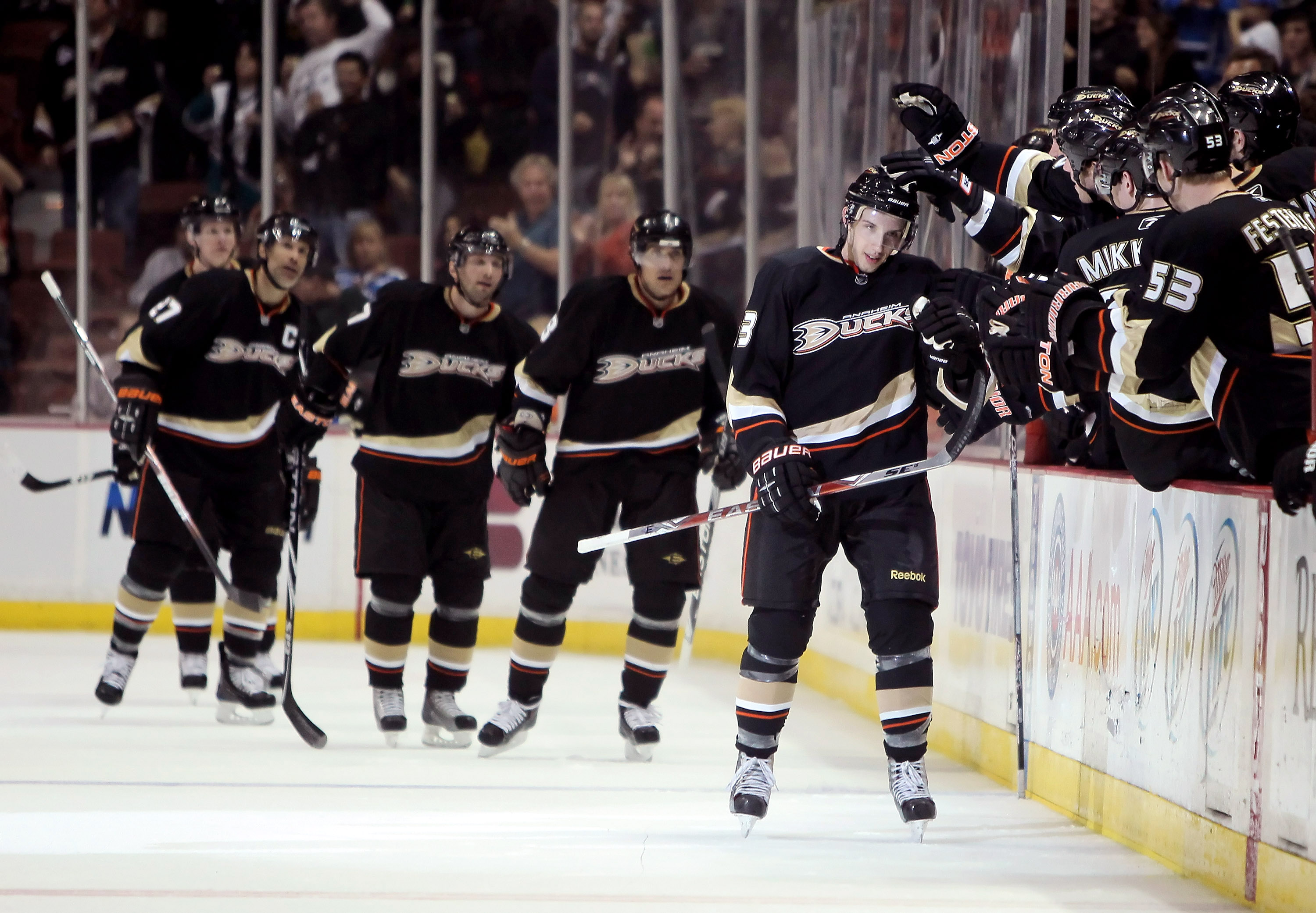 ANAHEIM, CA - MARCH 29:  Nick Bonino (R) #63 of the Anaheim Ducks receives high fives from the bench after scoring his first NHL goal in the second period against the Dallas Stars at the Honda Center on March 29, 2010 in Anaheim, California.  (Photo by Je