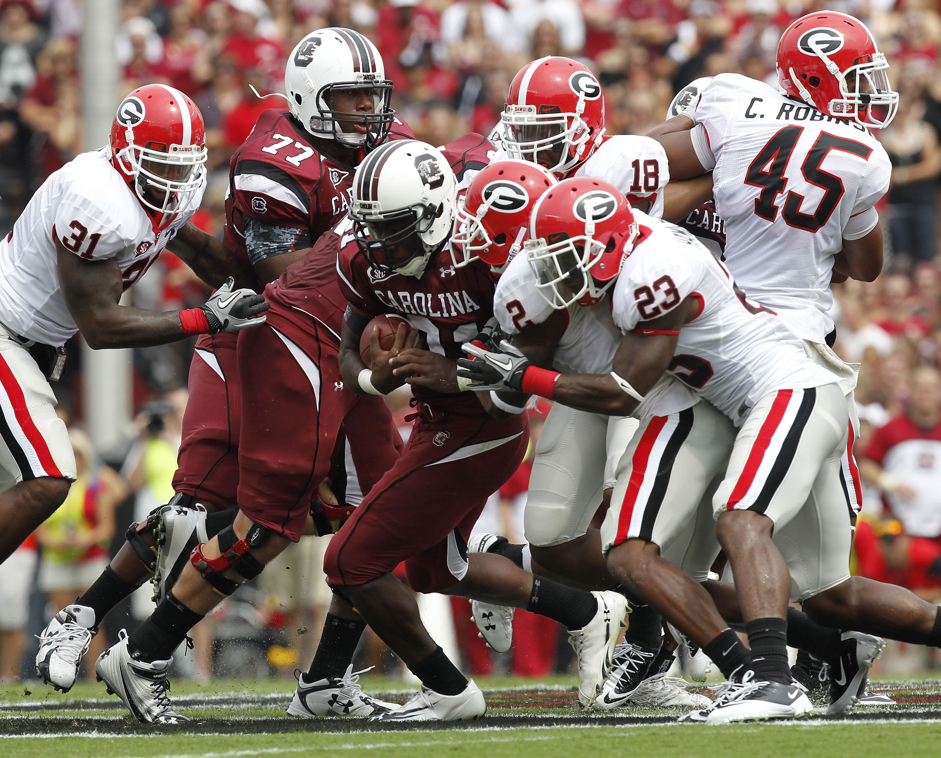 COLUMBIA, SC - SEPTEMBER 11: Tailback Marcus Lattimore #21 of the South Carolina Gamecocks (center with ball) is tackled by cornerback Brandon Boykin #2 and free safety Jakar Hamilton #23 of the Georgia Bulldogs during the game at Williams-Brice Stadium o COLUMBIA, SC - SEPTEMBER 11: Tailback Marcus Lattimore #21 of the South Carolina Gamecocks (center with ball) is tackled by cornerback Brandon Boykin #2 and free safety Jakar Hamilton #23 of the Georgia Bulldogs during the game at Williams-Brice Stadium o