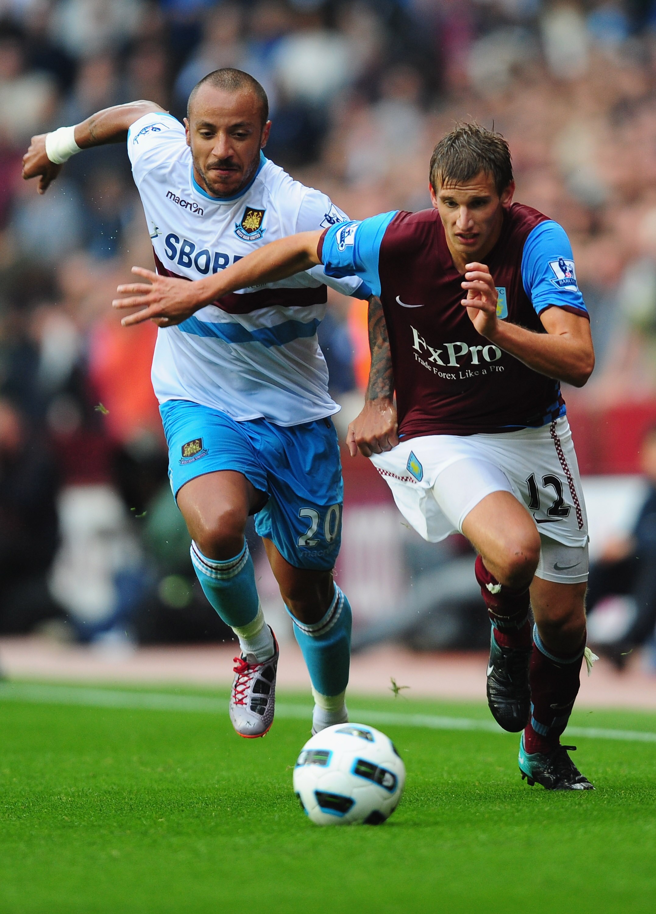 BIRMINGHAM, ENGLAND - AUGUST 14:  Marc Albrighton (R) of Aston Villa battles with Julien Faubert of West Ham United  during the Barclays Premier League match between Aston Villa and West Ham United at Villa Park on August 14, 2010 in Birmingham, England.