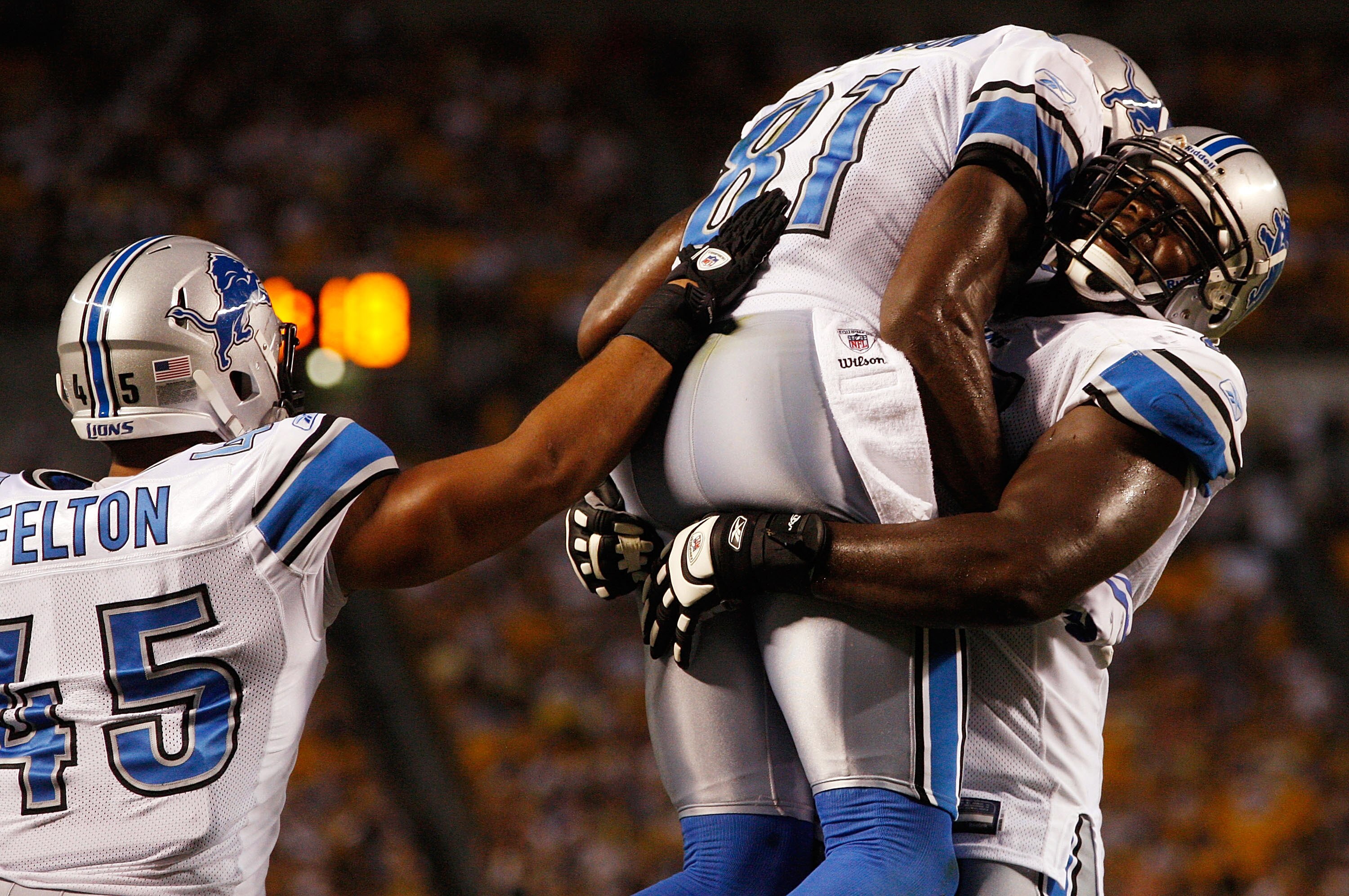 PITTSBURGH - AUGUST 14:  Calvin Johnson #81 of the Detroit Lions celebrates with teammates Jerome Felton #45 and Gosder Cherilus #77 during the preseason game against the Pittsburgh Steelers on August 14, 2010 at Heinz Field in Pittsburgh, Pennsylvania.